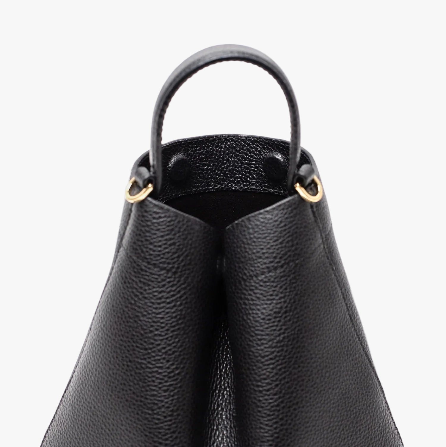 Close up of STOW London's Mini Curve in Black pebbled leather featuring hidden magnets, suede lining and gold hardware on a light grey background