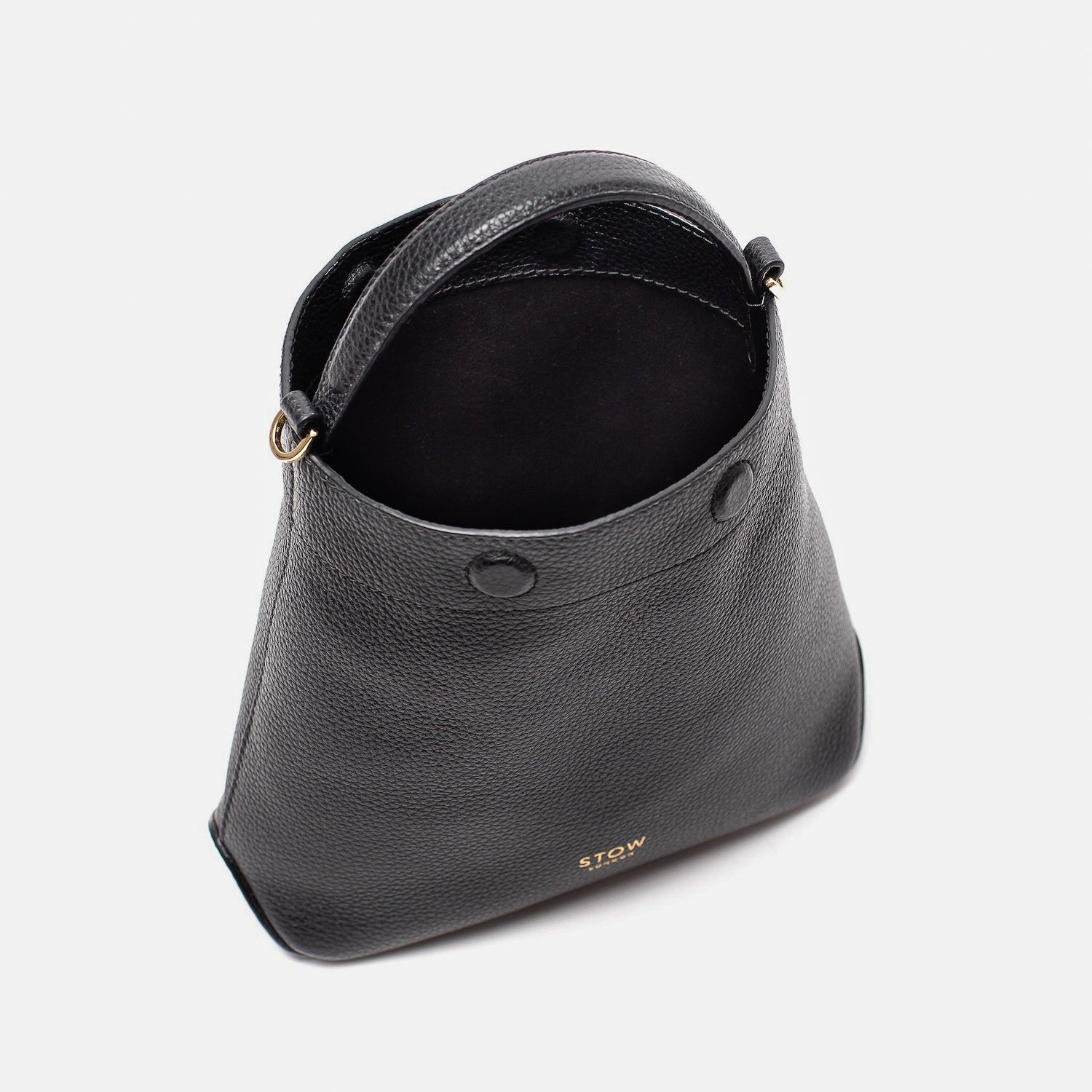 STOW London's Mini Curve in Black pebbled leather with magnets open showing black suede interior lining on a light grey background