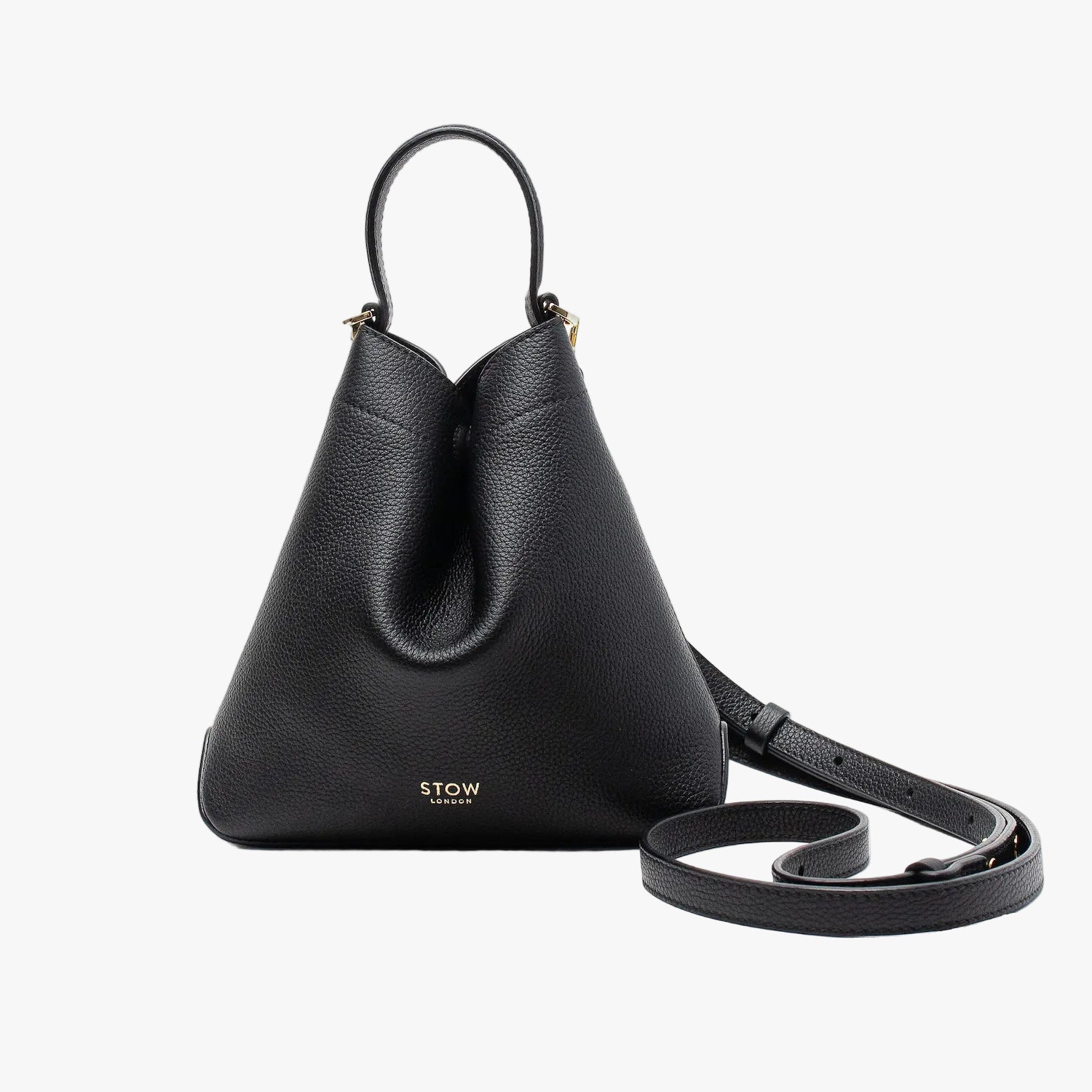 STOW London's Mini Curve in Black pebbled leather and detachable leather crossbody strap on a light grey background