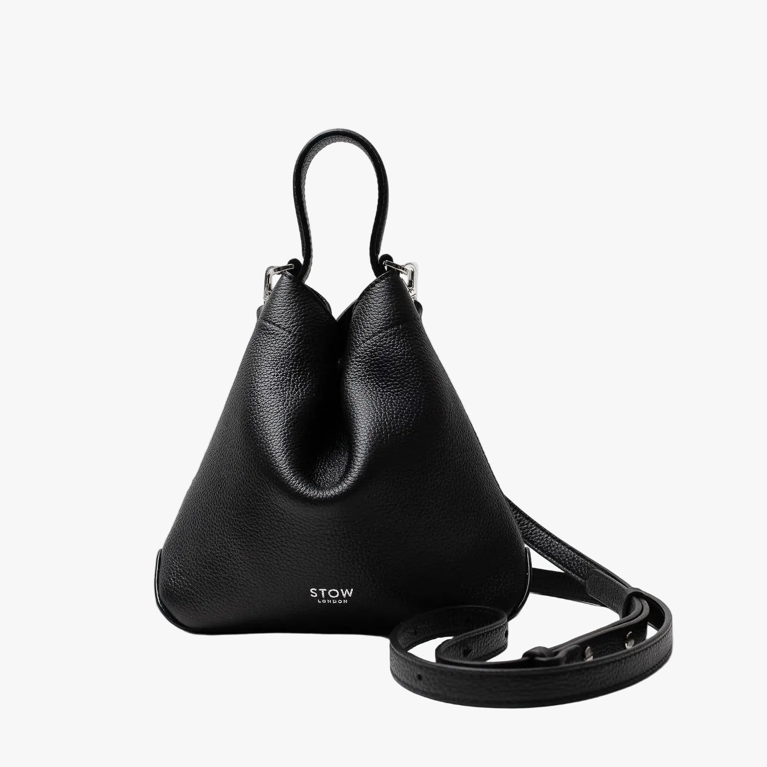 STOW London's Mini Curve in Black pebbled leather and detachable leather crossbody strap on a light grey background