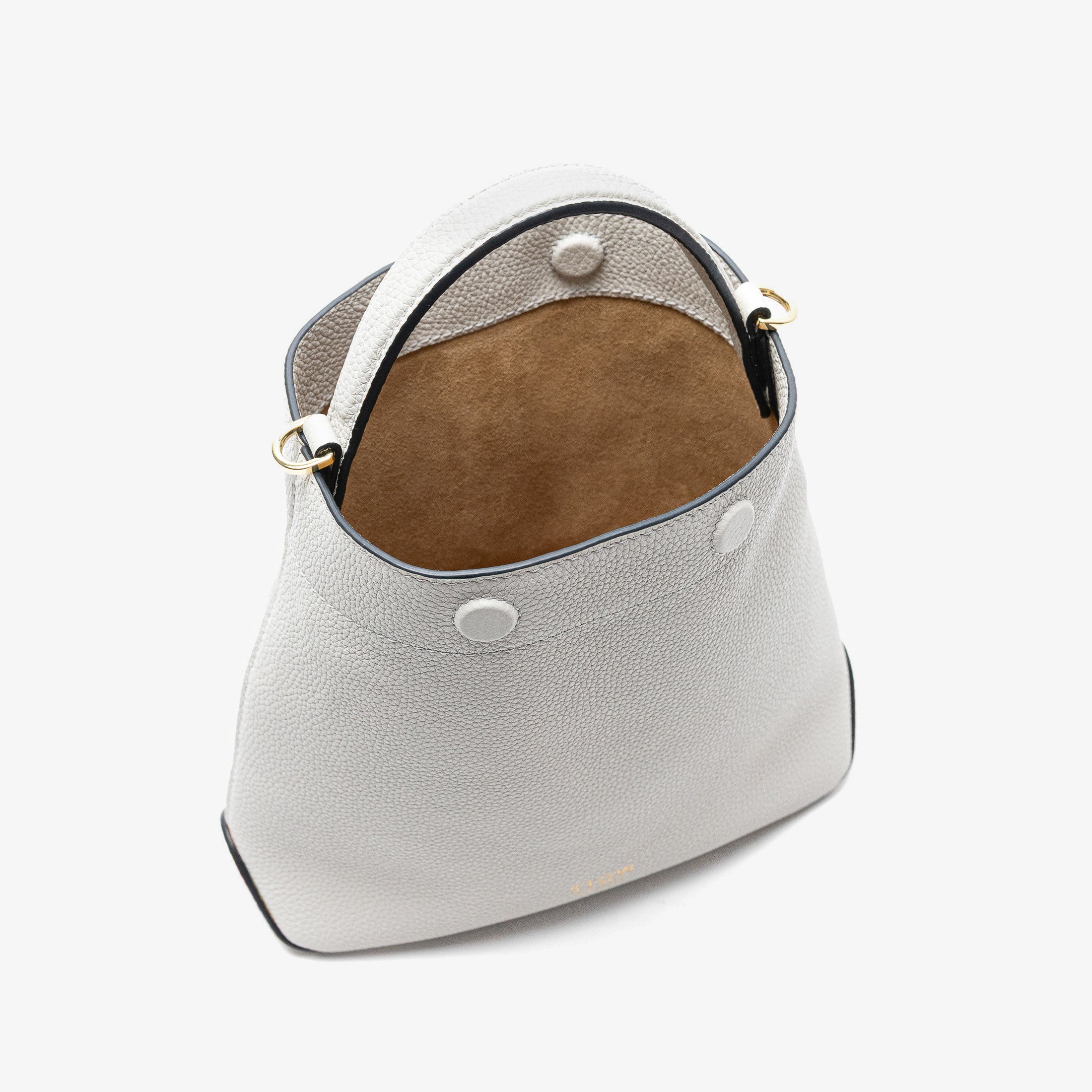 Stow London's Mini Curve in Cloud Grey pebbled leather with magnets open showing hidden magnet closures and cognac suede interior lining on a light grey background