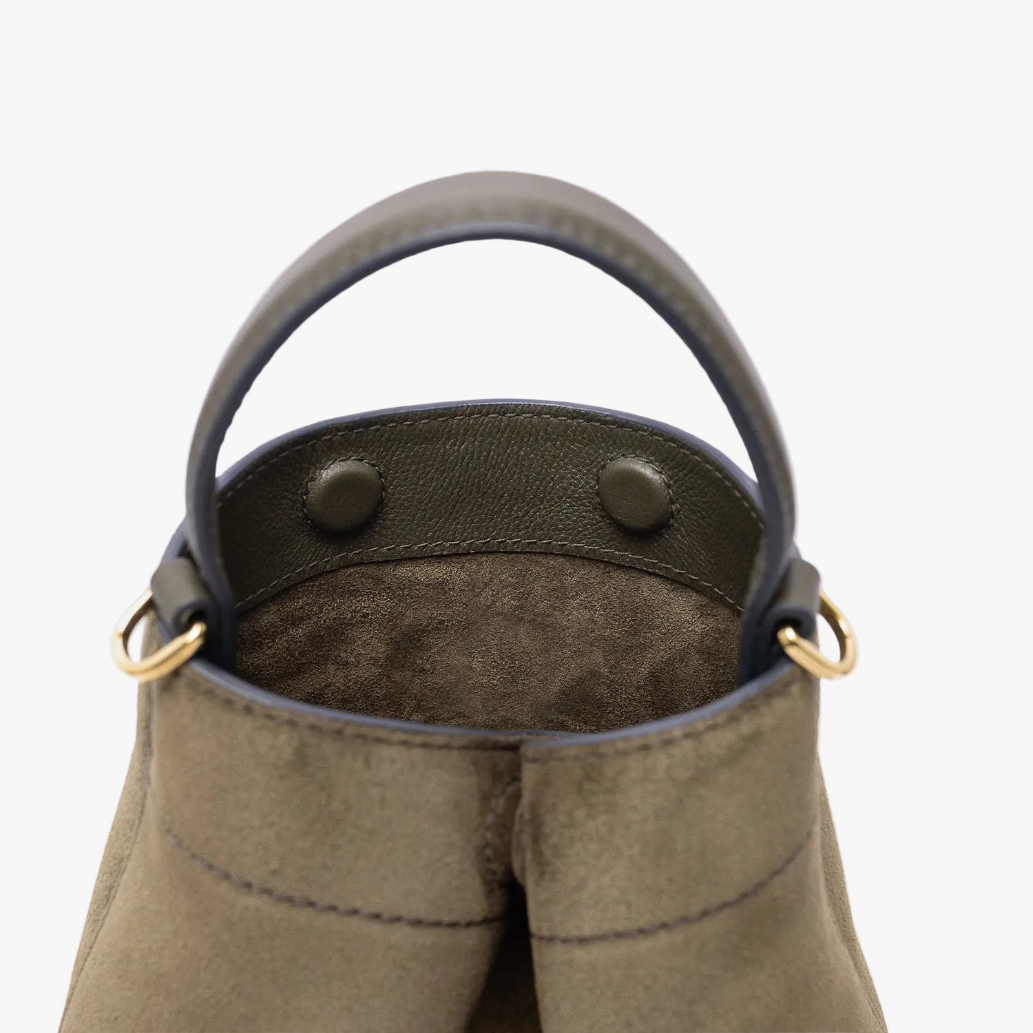 Close up of the top of Stow London's Mini Curve in Dark Green suede leather featuring hidden magnets and gold-coated stainless steel hardware on a light grey background