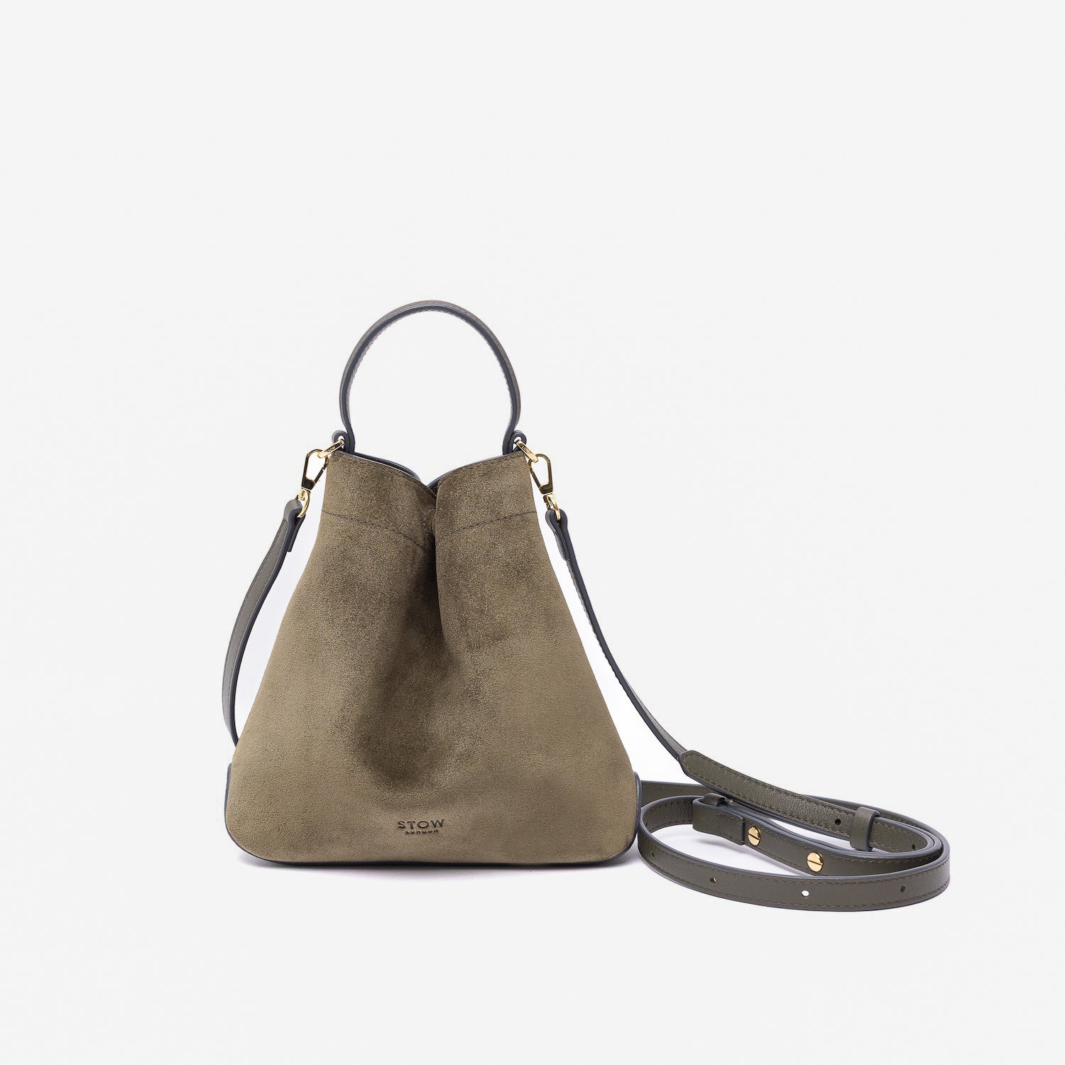 STOW London's Mini Curve in Dark Green suede leather and detachable leather crossbody strap on a light grey background