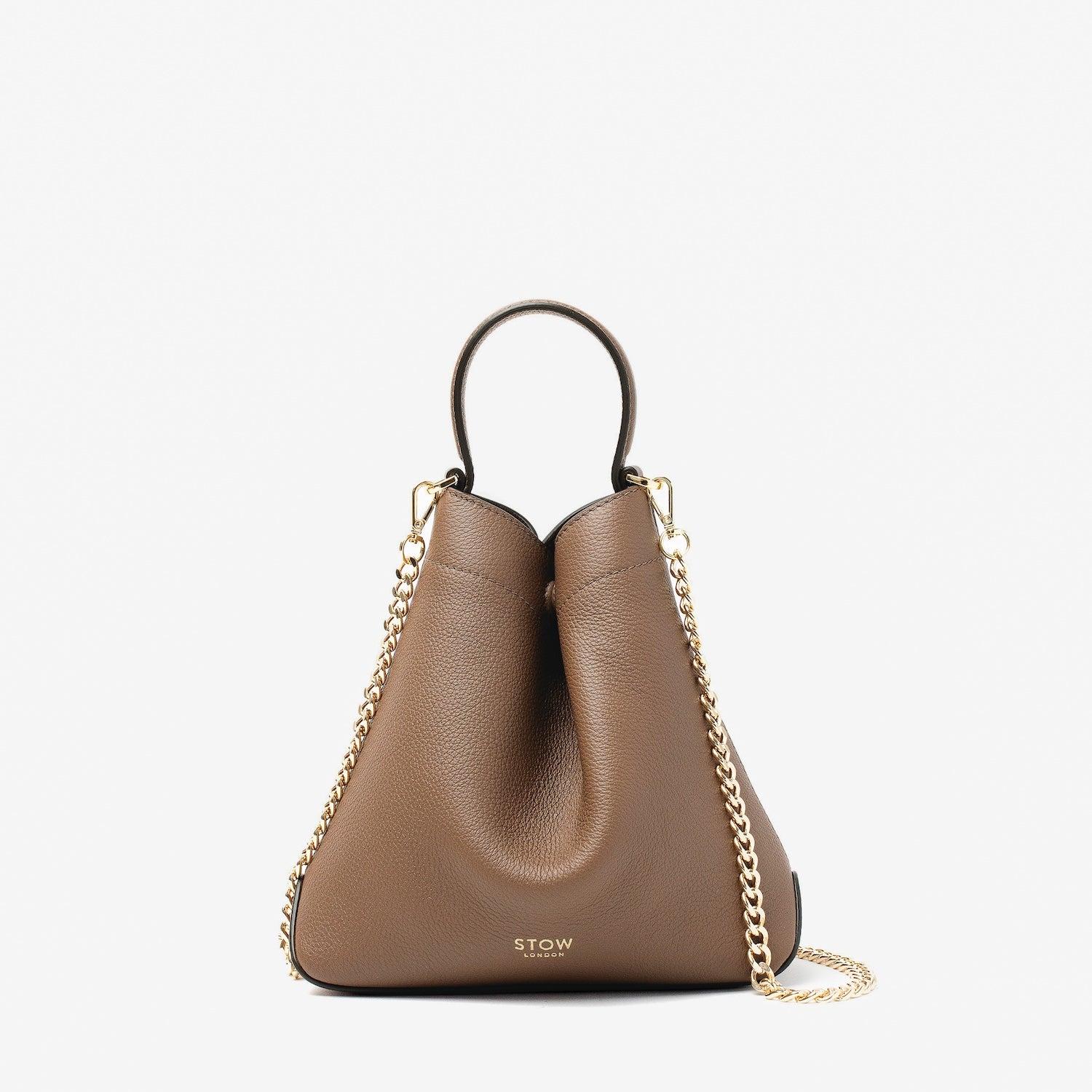 STOW London's Mini Curve in Mocha pebbled leather and detachable gold chain crossbody strap on a light grey background