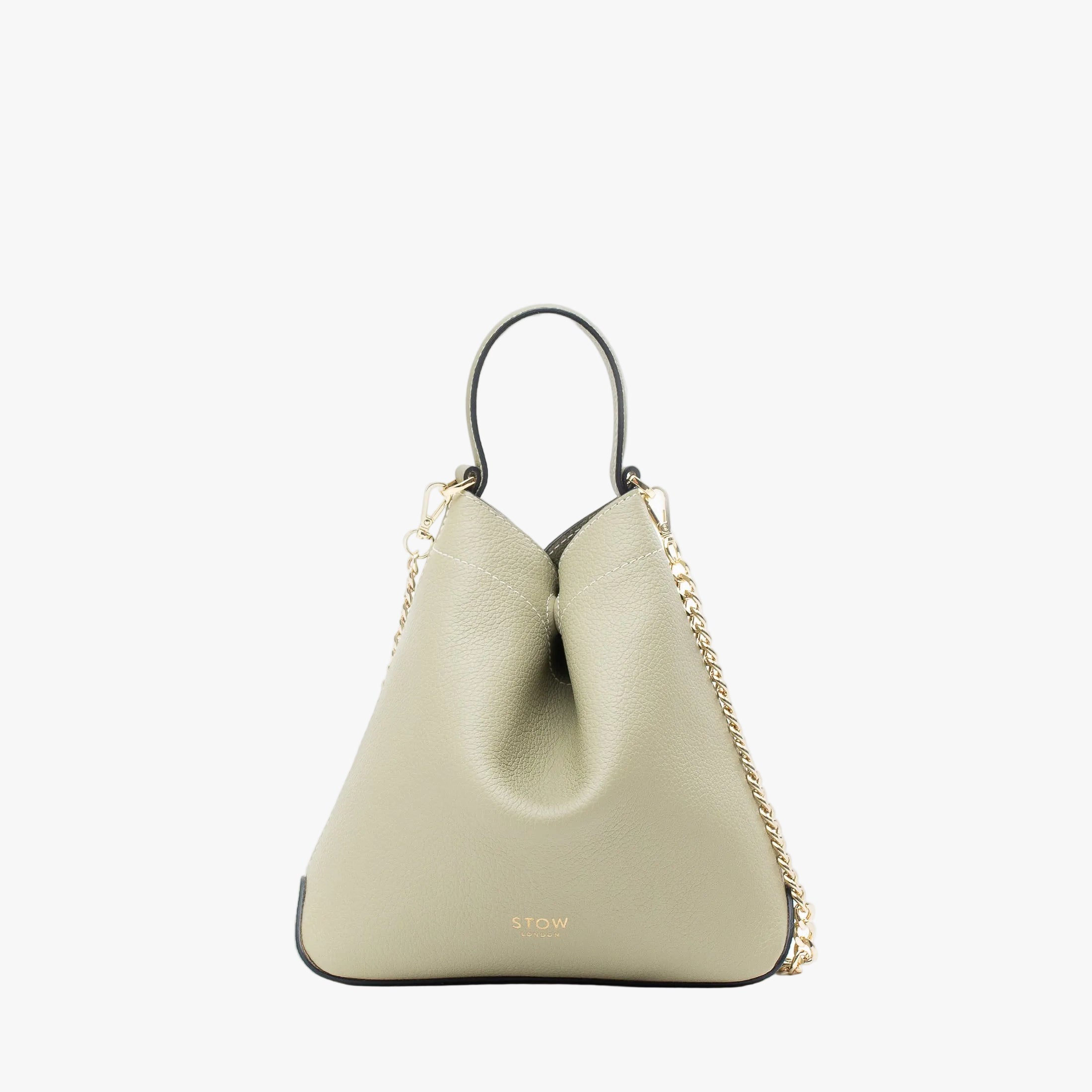 STOW London's Mini Curve in Pale Green pebbled leather and detachable gold chain crossbody strap on a light grey background