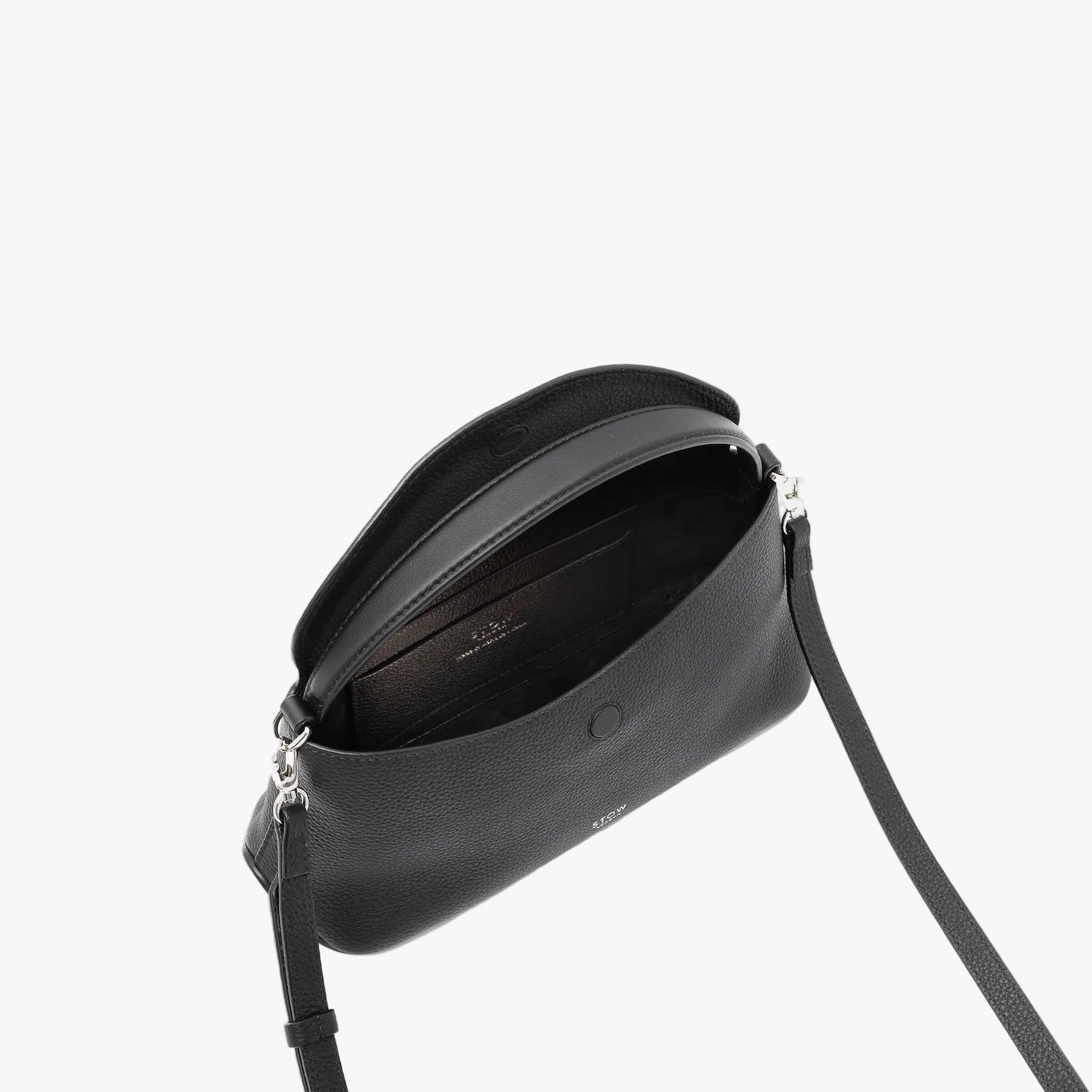 STOW London's Mini East West in Black pebbled leather with flap open showing suede interior and slip pocket featuring silver stainless steel hardware on a light grey background