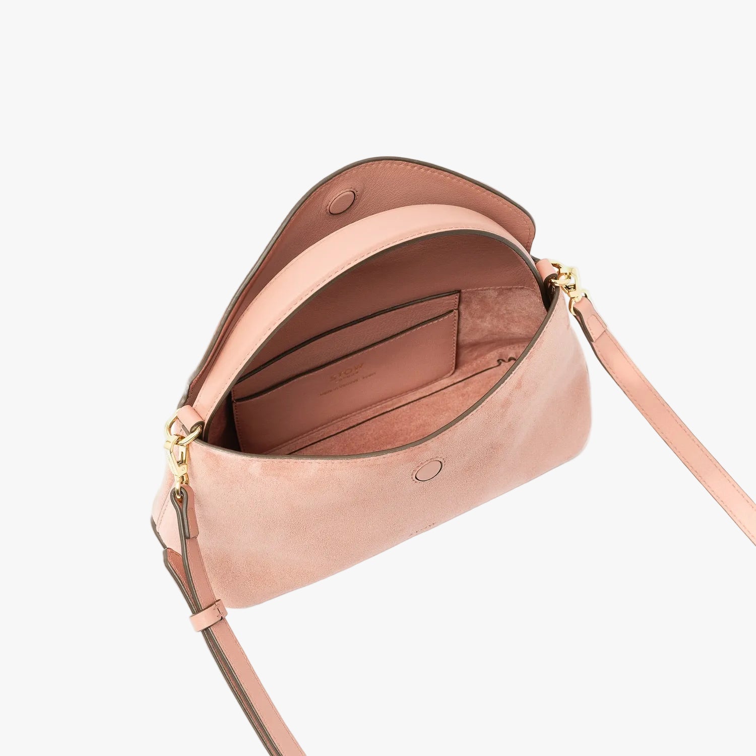 STOW London's Mini East West in Hazy Blush suede leather with flap open showing suede interior and slip pocket featuring gold-coated stainless steel hardware on a light grey background