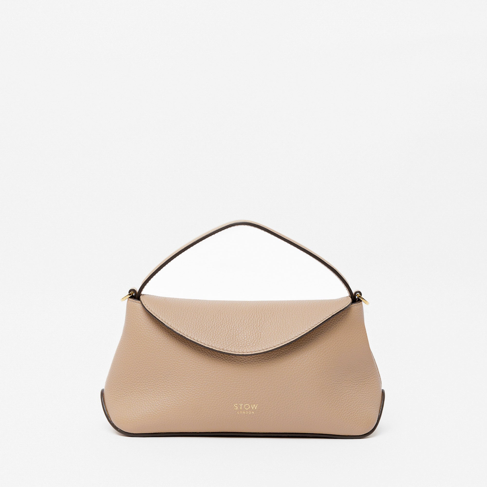 STOW London's Mini East West in Camel pebbled leather featuring gold-coated stainless steel hardware on a light grey background