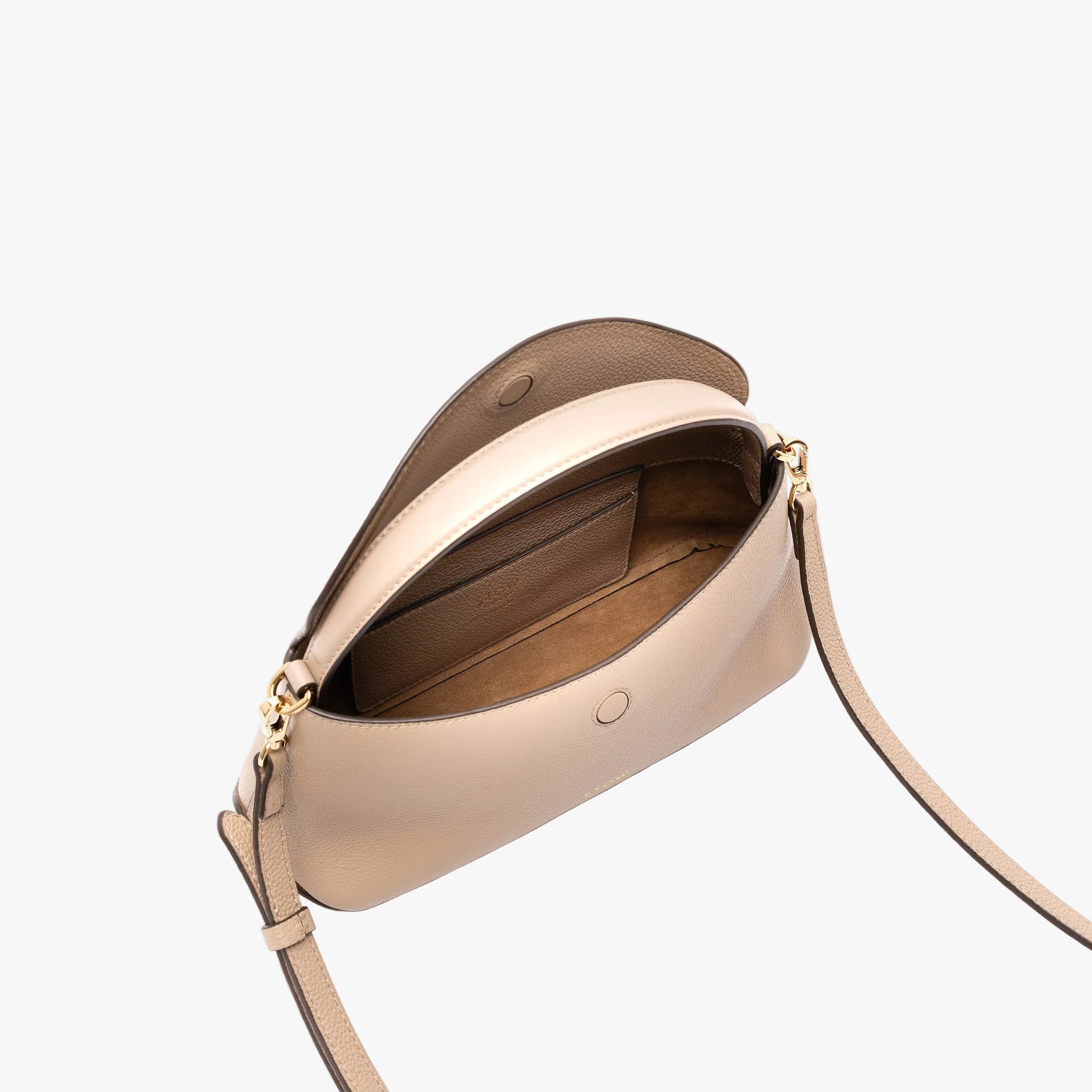 STOW London's Mini East West in Camel pebbled leather with flap open showing suede interior and slip pocket featuring gold-coated stainless steel hardware on a light grey background