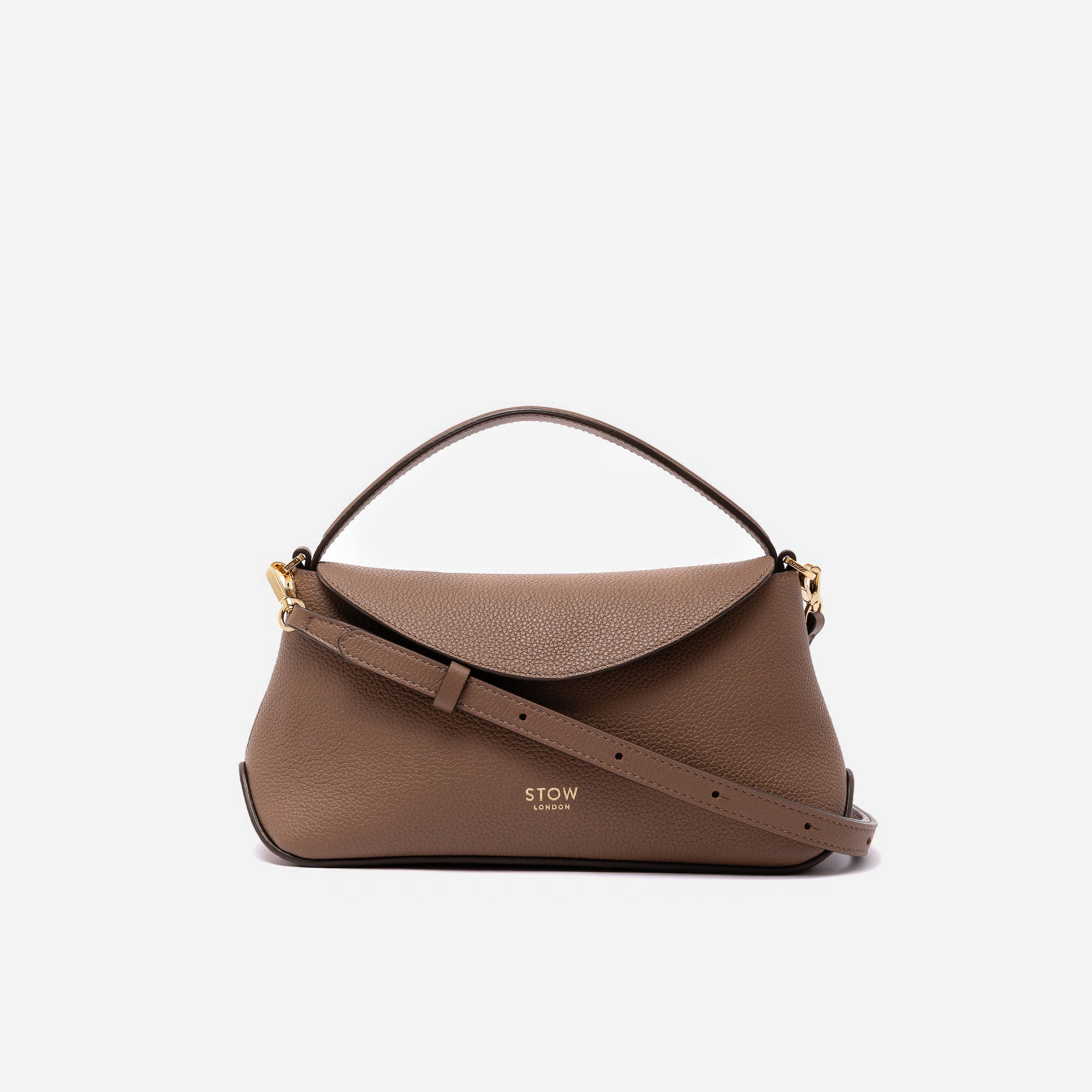 STOW London's Mini East West in Mocha pebbled leather and detachable crossbody strap featuring gold-coated stainless steel hardware on a light grey background