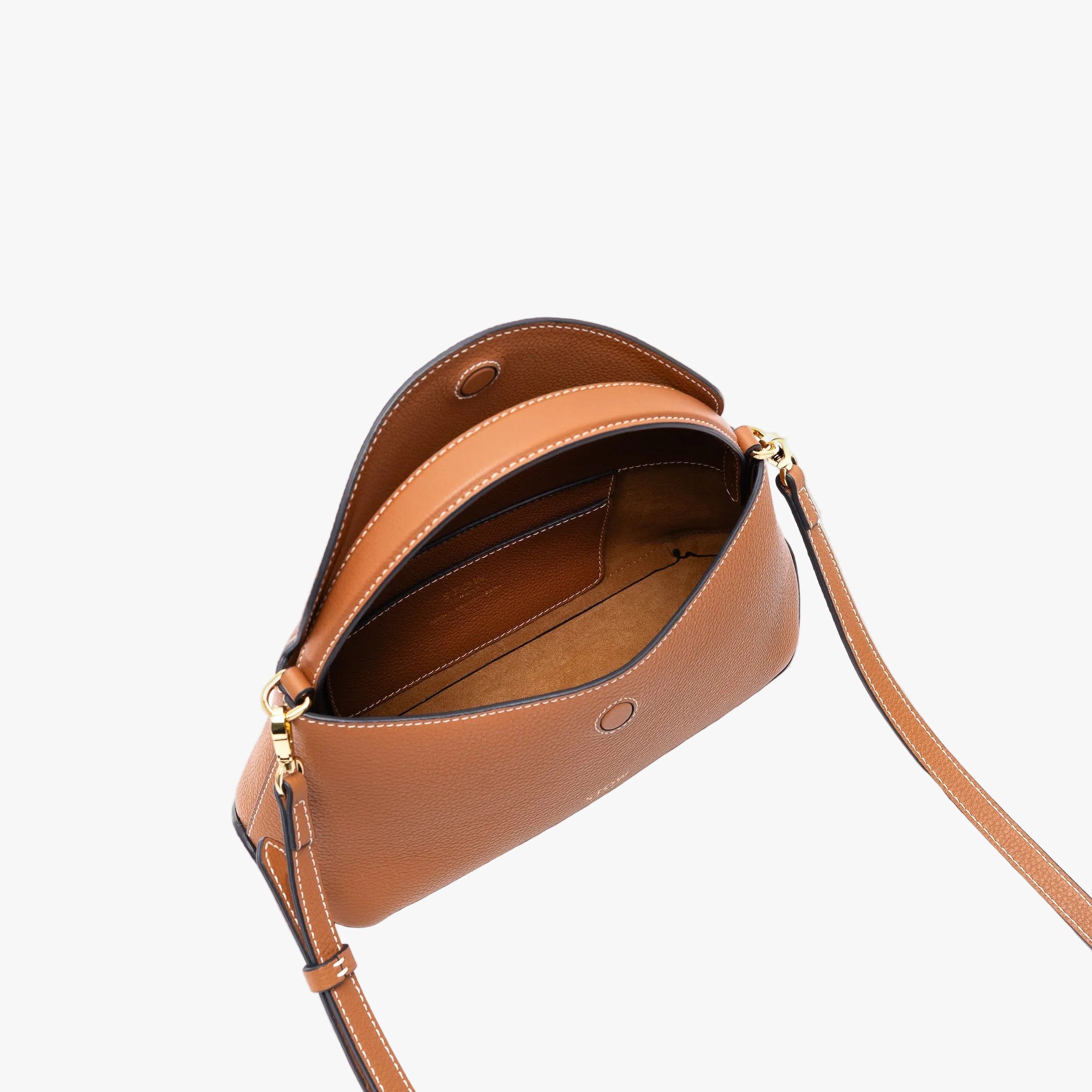 STOW London's Mini East West in Earth Tan pebbled leather with flap open showing suede interior and slip pocket featuring gold-coated stainless steel hardware on a light grey background