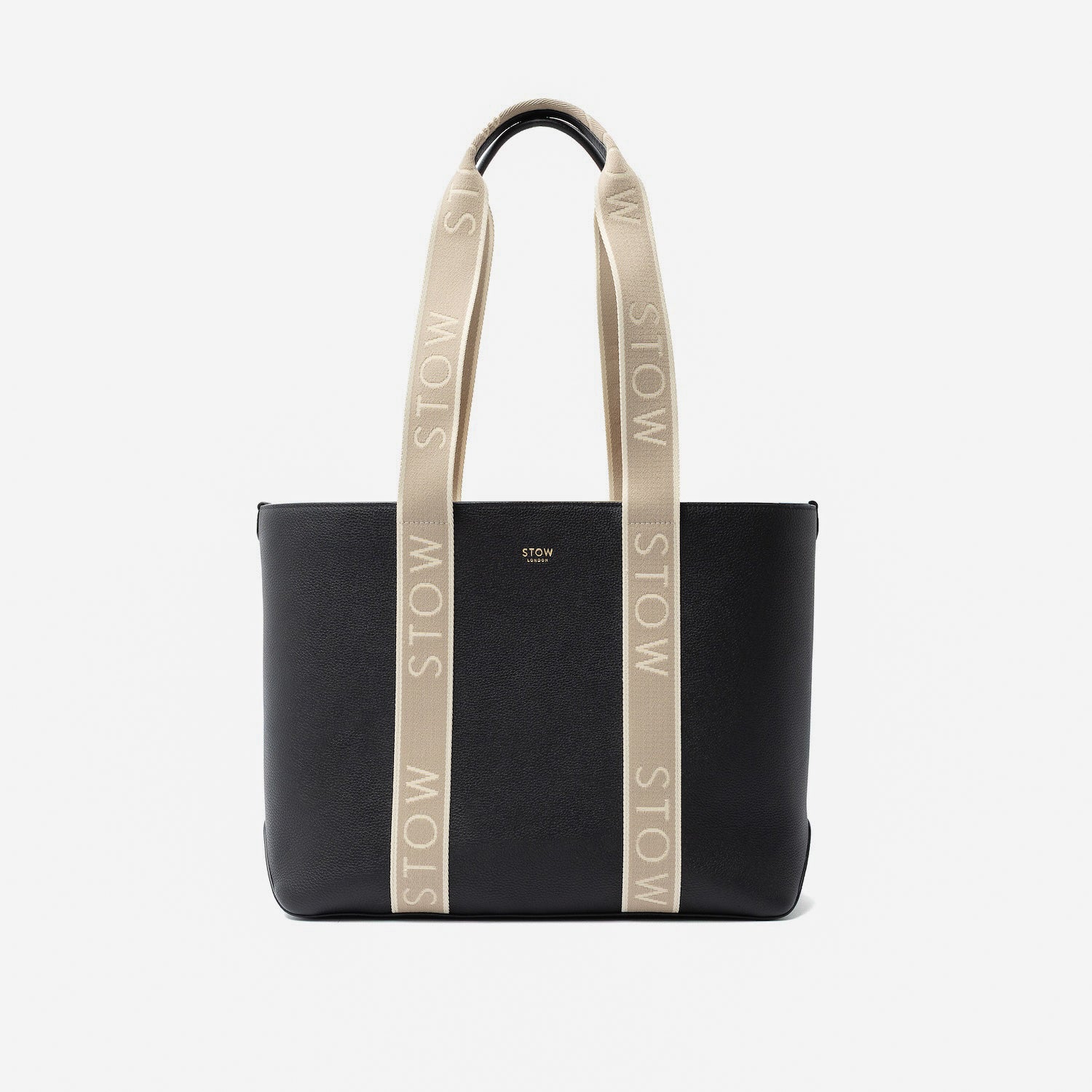 STOW London's Nastro Tote bag in Black pebbled leather with beige nastro handles featuring 'STOW' branding on a light grey background