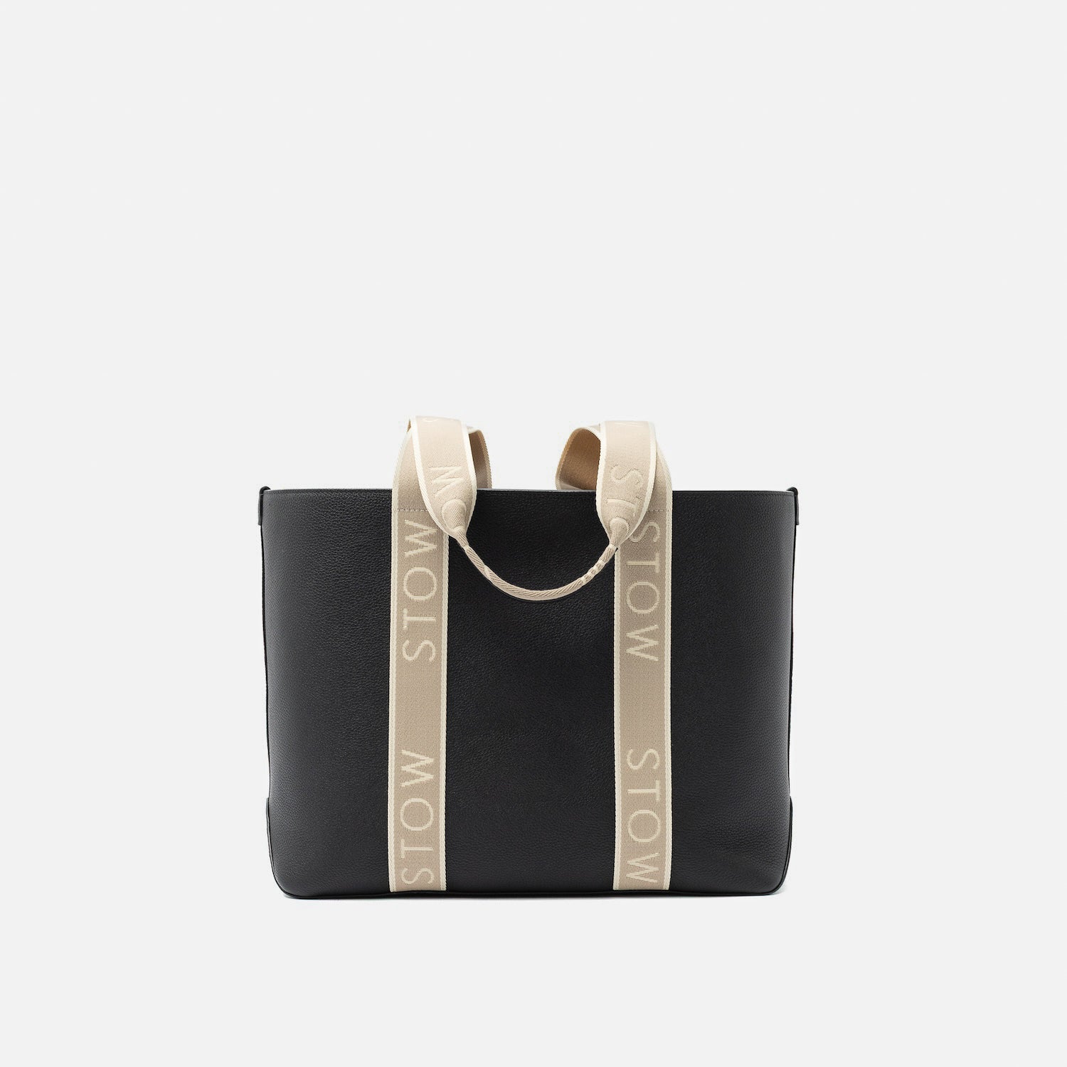 STOW London's Nastro Tote bag in Black pebbled leather with beige nastro handles featuring 'STOW' branding on a light grey background