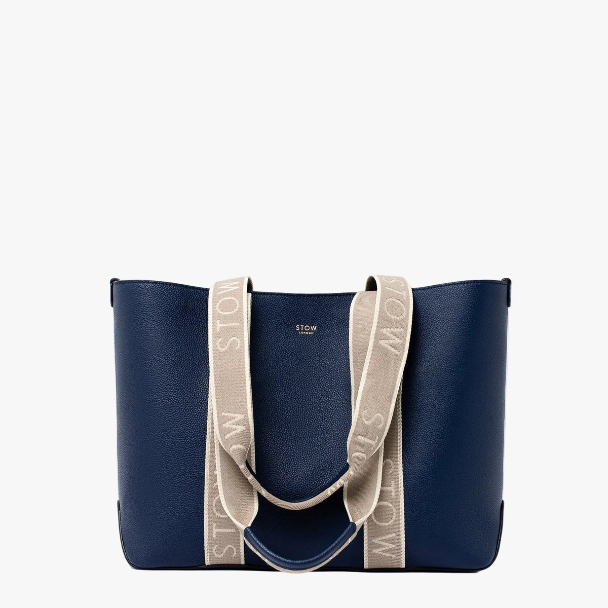 STOW London's Nastro Tote bag in Navy pebbled leather with beige nastro handles featuring 'STOW' branding on a light grey background