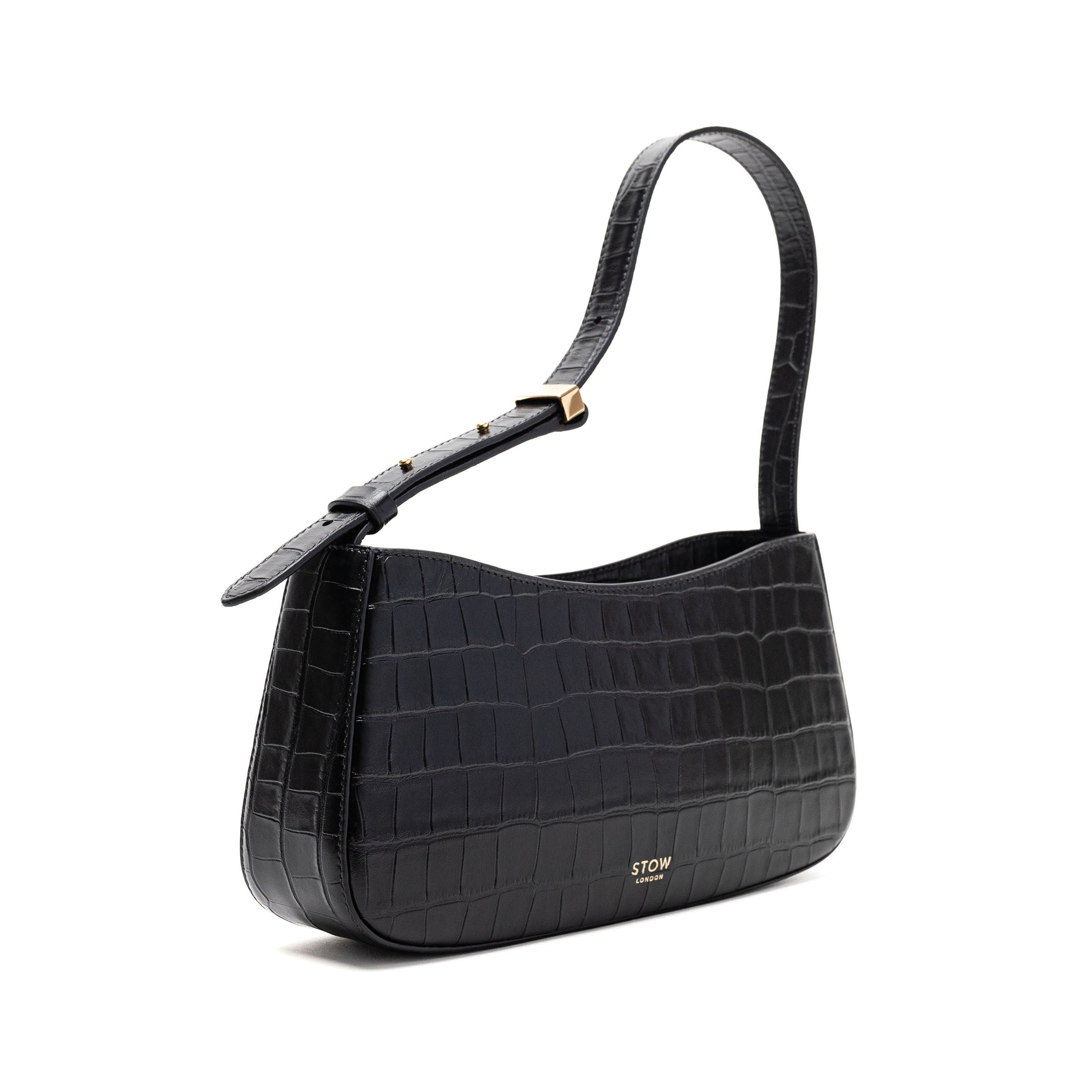 Off-axis view of STOW London's Post Shoulder bag in Black Embossed Croc leather featuring gold-coated stainless steel hardware on a white background