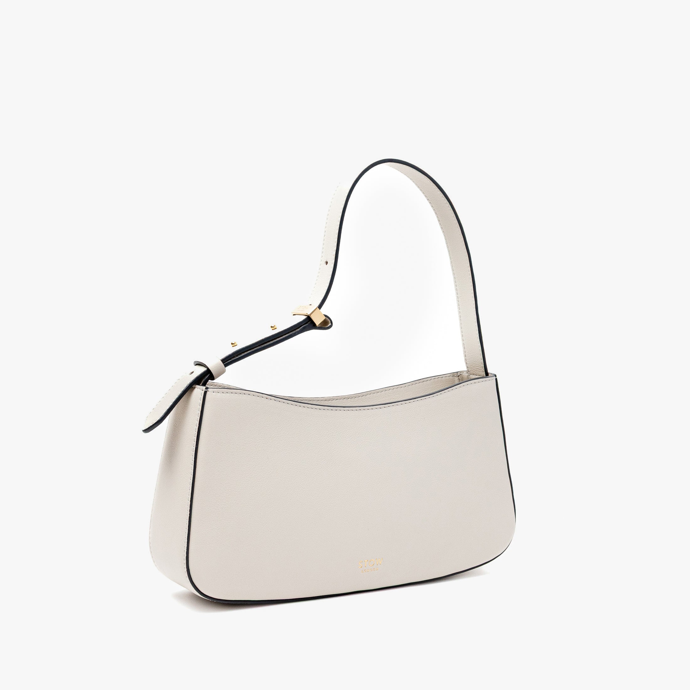 Off-axis view of Stow London's Post Shoulder in Cloud Grey smooth leather on a light grey background featuring gold-coated stainless steel hardware