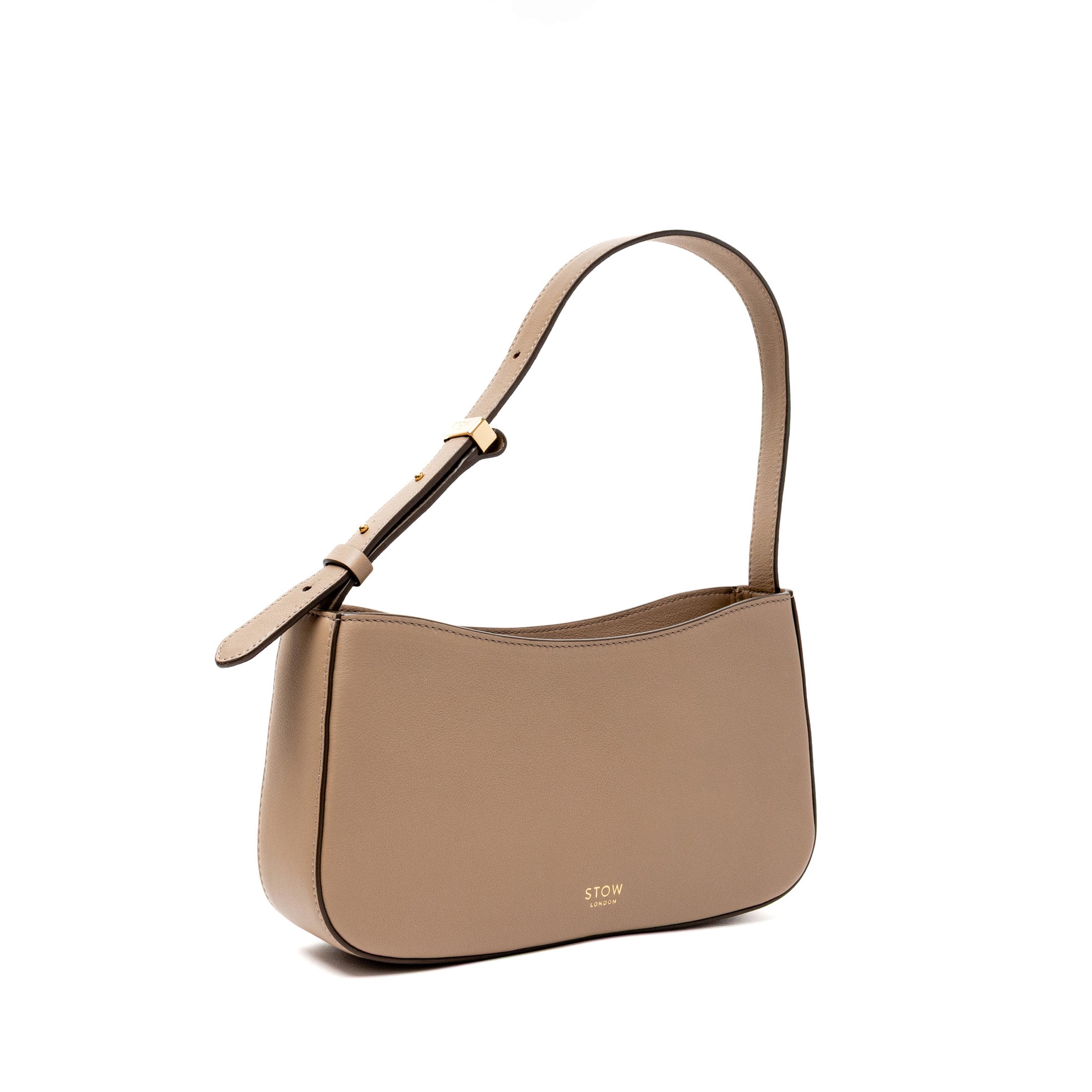Off-axis view of STOW London's Post Shoulder bag in Warm Taupe smooth leather featuring gold-coated stainless steel hardware on a white background