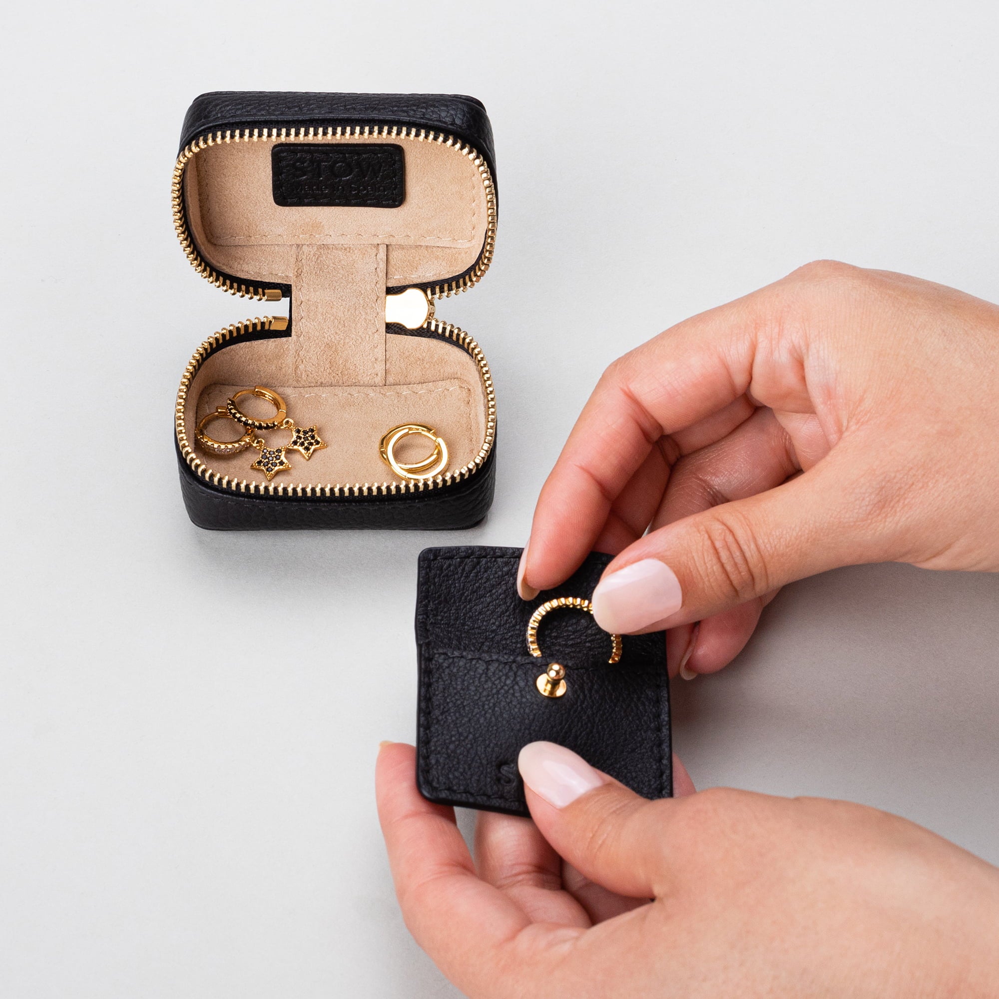 STOW London Mini Essentials Case in Black leather, showing leather sleeve included inside
