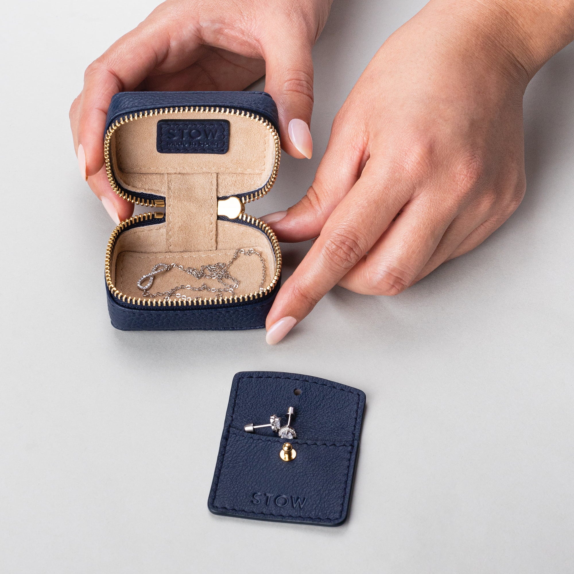 STOW London Mini Essentials Case in Navy leather, showing leather sleeve included inside