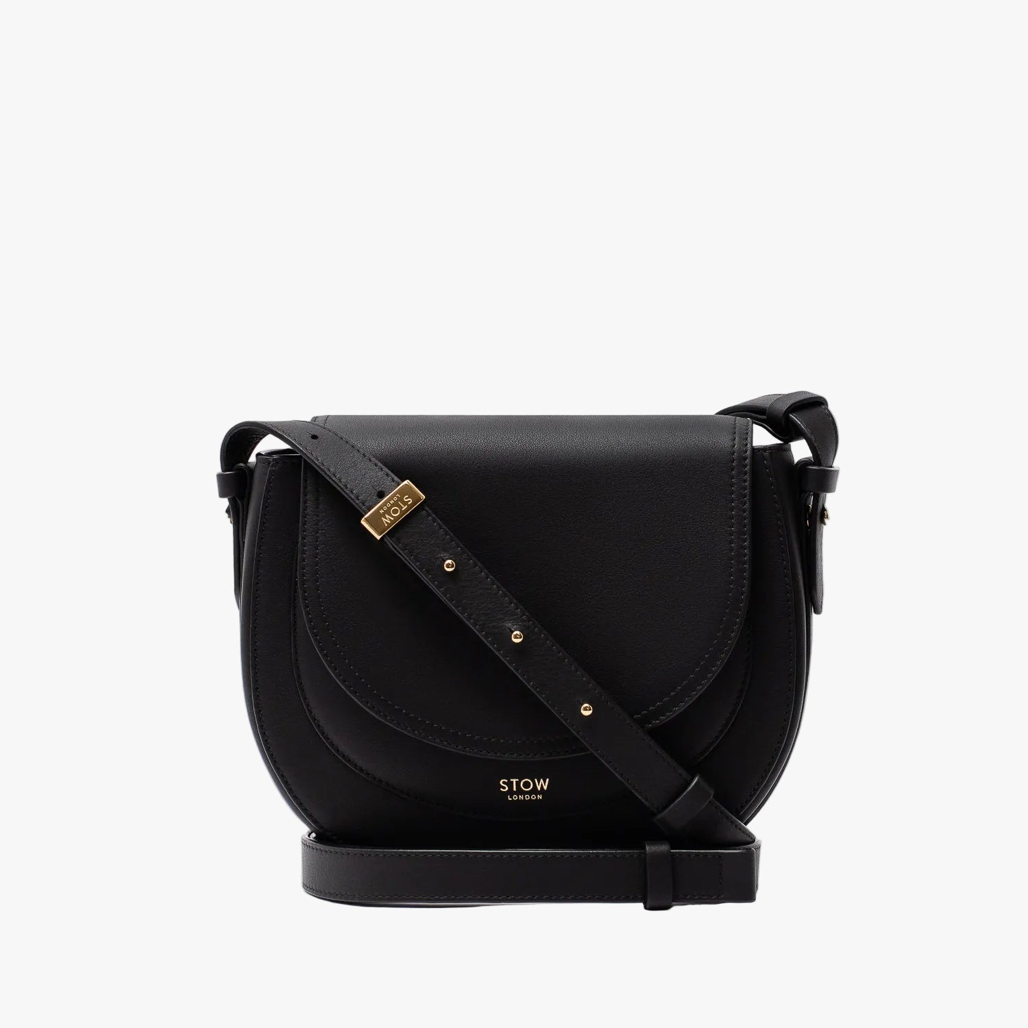 STOW London's Saddle bag in Black smooth leather and detachable crossbody strap with gold-coated stainless steel hardware on a light grey background