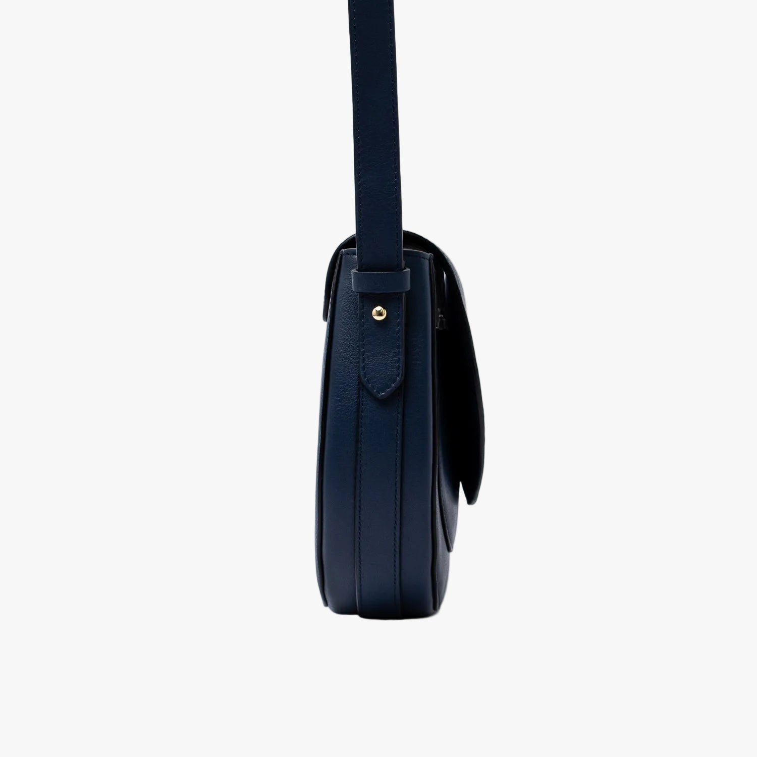 Side view of STOW London's Saddle bag in Navy smooth leather on a light grey background