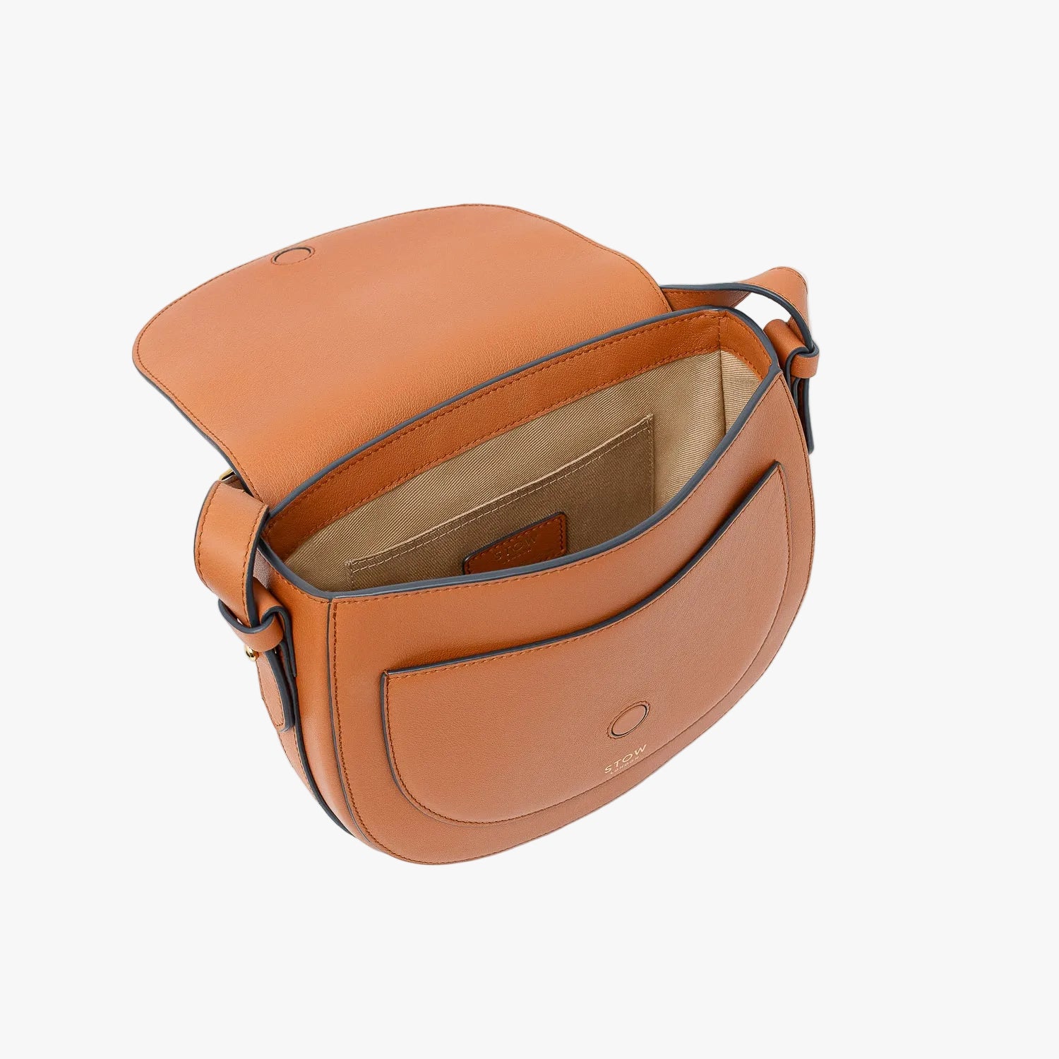STOW London's Saddle bag in Earth Tan smooth leather with magnet open showing light beige cotton interior and slip pocket on a light grey background