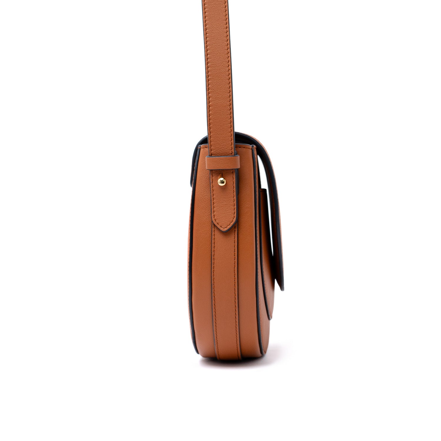 Side view of STOW London's Saddle bag in Earth Tan smooth leather and its detachable crossbody strap on a white background