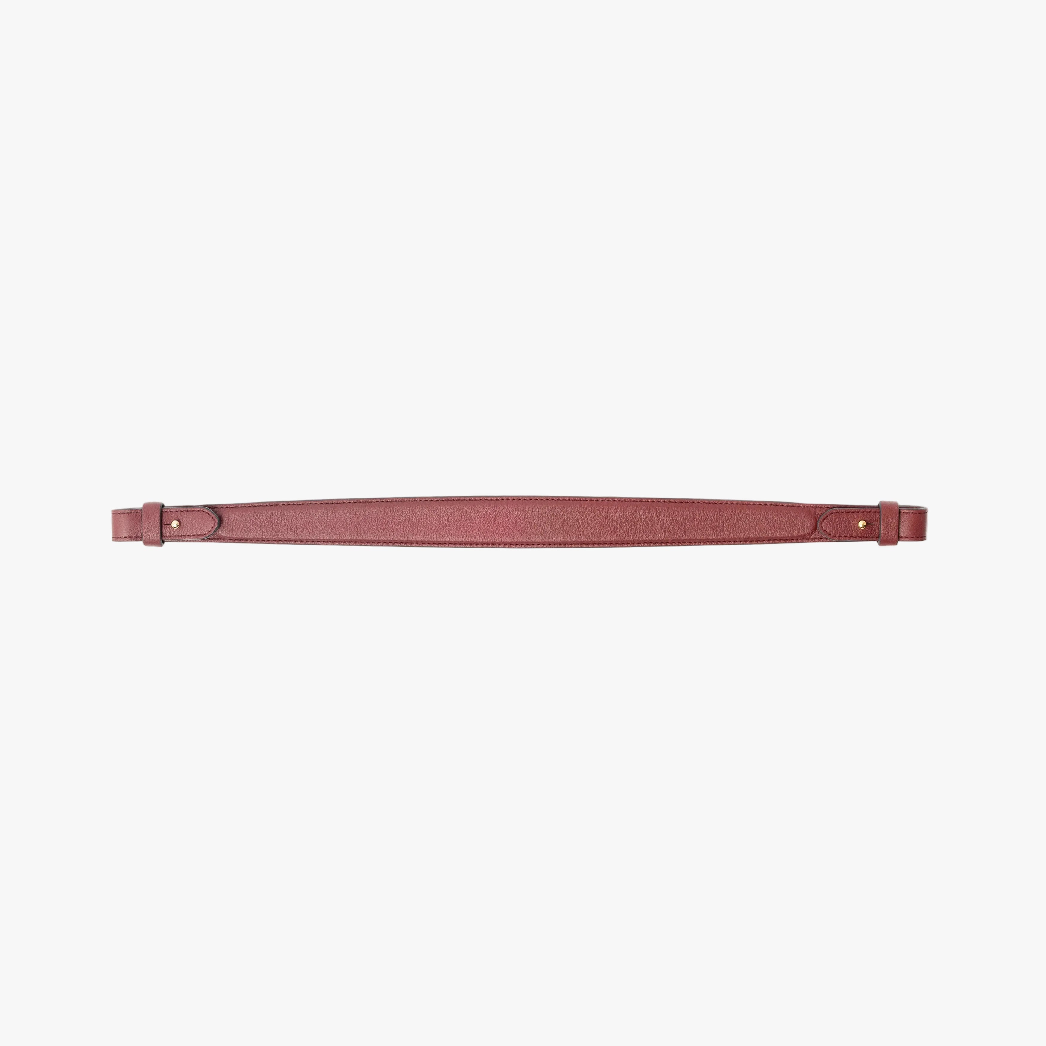 Detachable shoulder strap for STOW London's Curve, Midi Curve and East West in Burgundy smooth leather on a light grey background featuring gold hardware