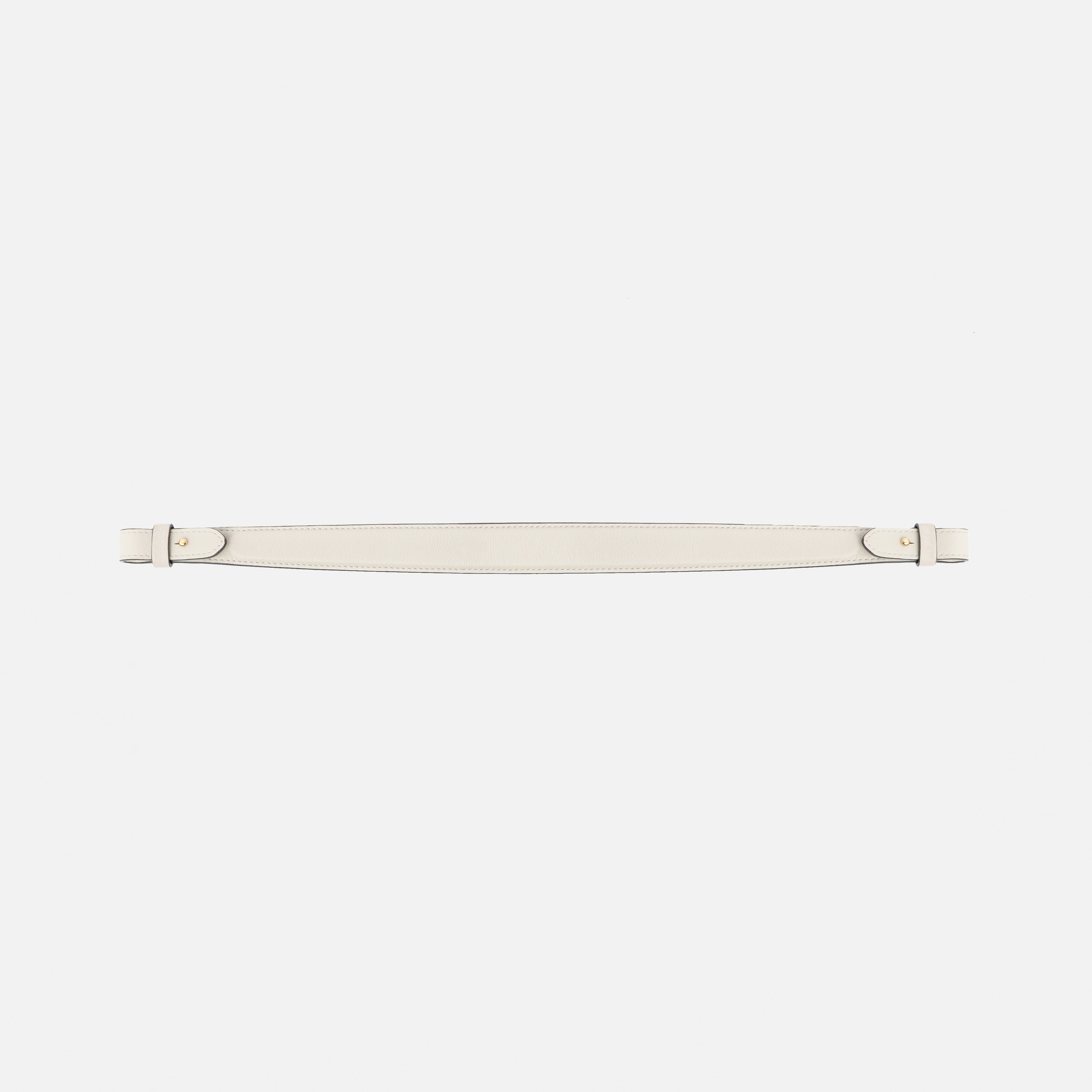 Detachable shoulder strap for STOW London's Curve, Midi Curve and East West in Cloud Grey smooth leather on a light grey background featuring gold hardware