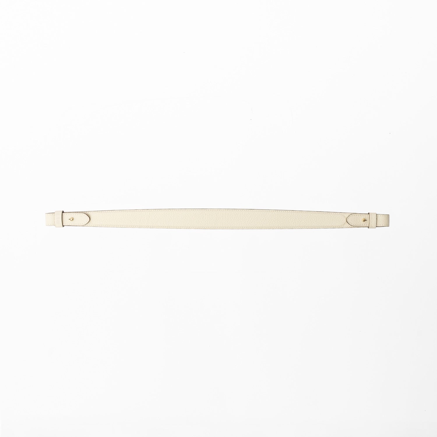 Detachable shoulder strap for STOW London's Curve, Midi Curve and East West in Spring Moon pebbled leather on a light grey background featuring gold hardware