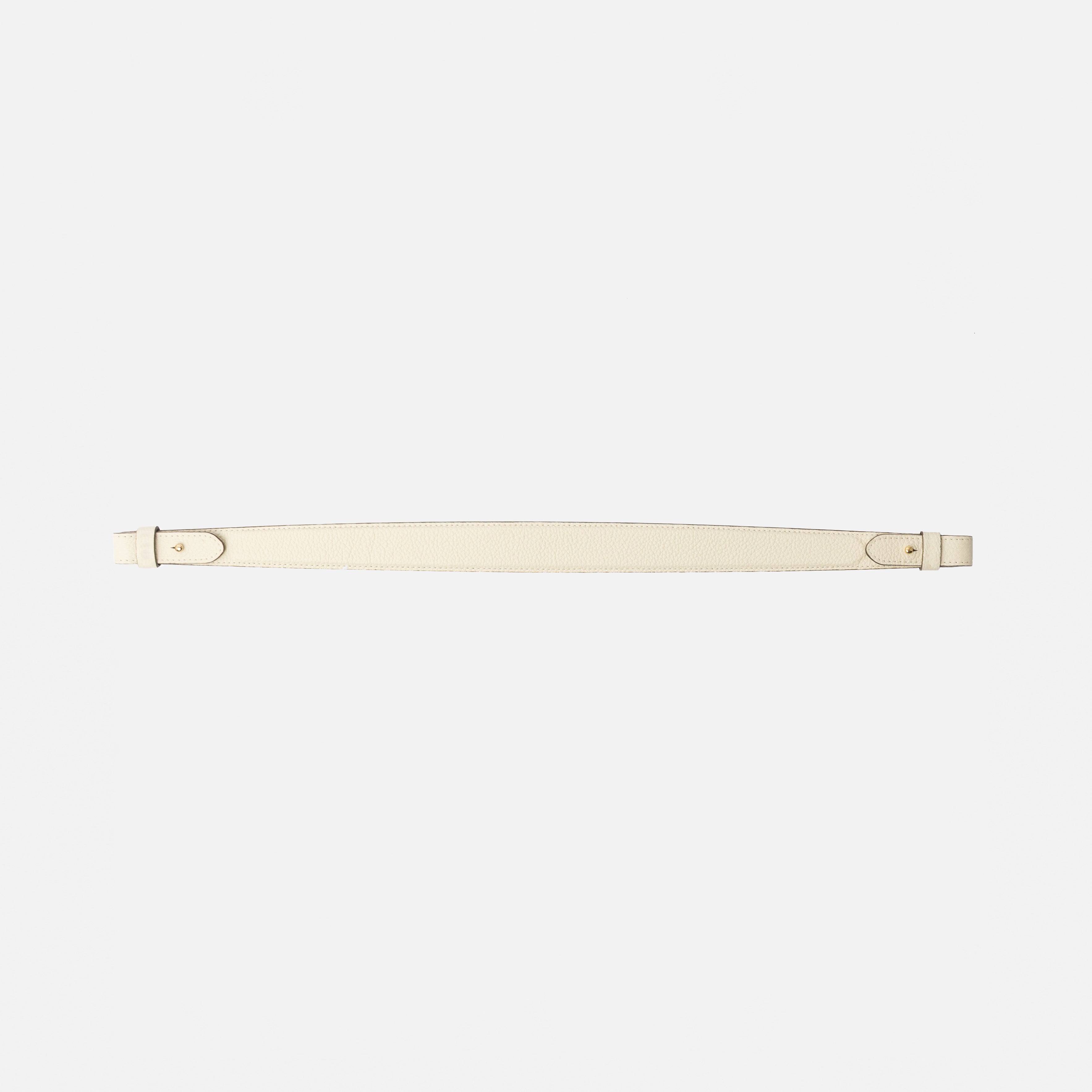 Detachable shoulder strap for STOW London's Curve, Midi Curve and East West in Spring Moon pebbled leather on a light grey background featuring gold hardware