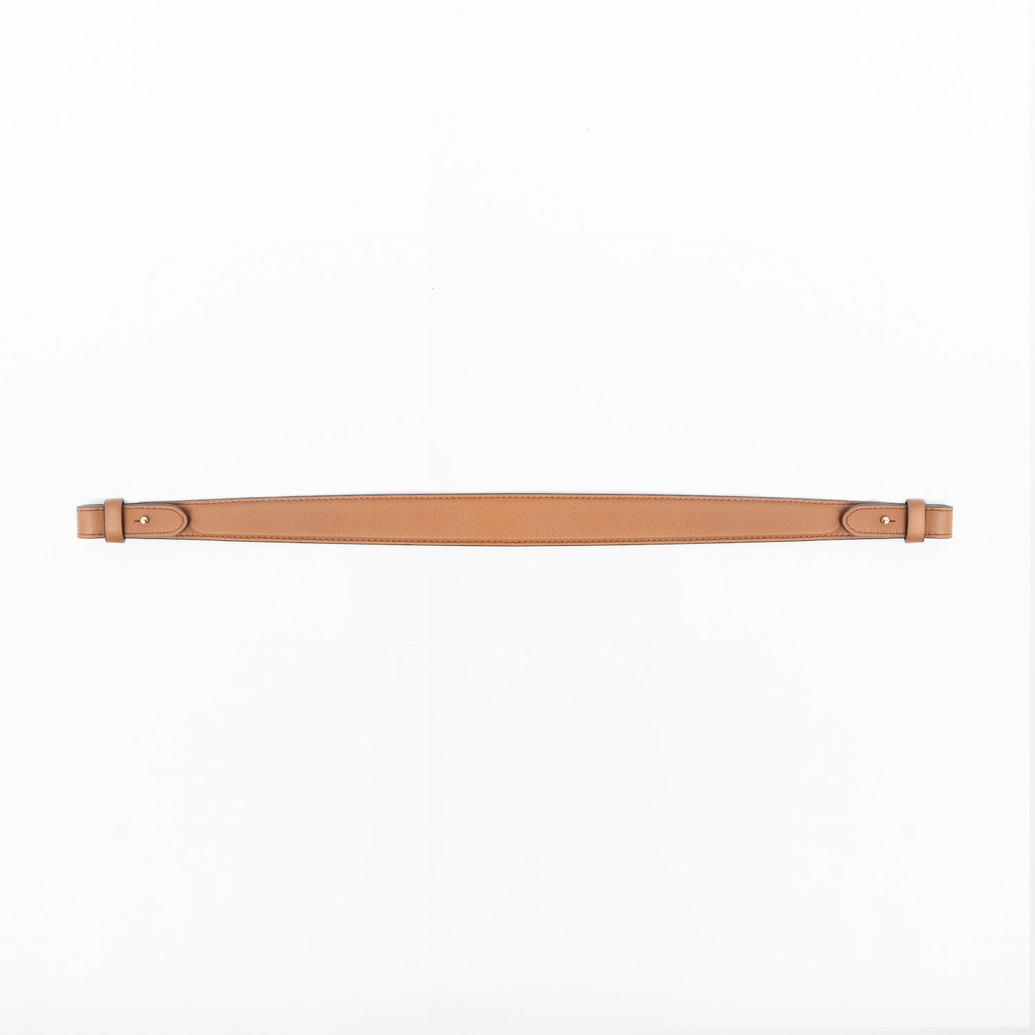 Detachable shoulder strap for STOW London's Curve, Midi Curve and East West in Earth Tan smooth leather on a light grey background featuring gold hardware