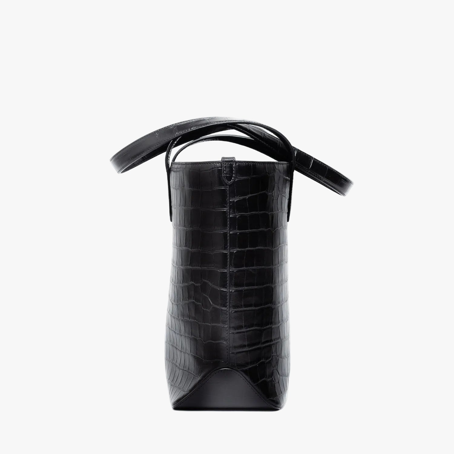 Side view of Stow London's Everyday Tote Bag in Black Embossed Croc leather on a light grey background