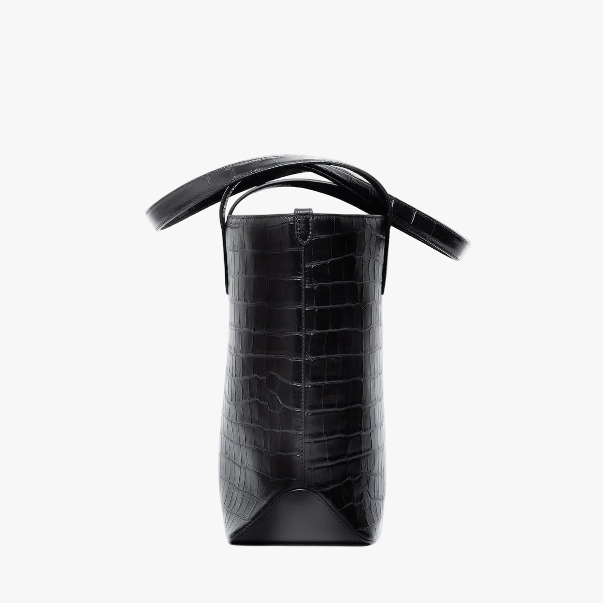 Side view of Stow London's Everyday Tote Bag in Black Embossed Croc leather on a light grey background