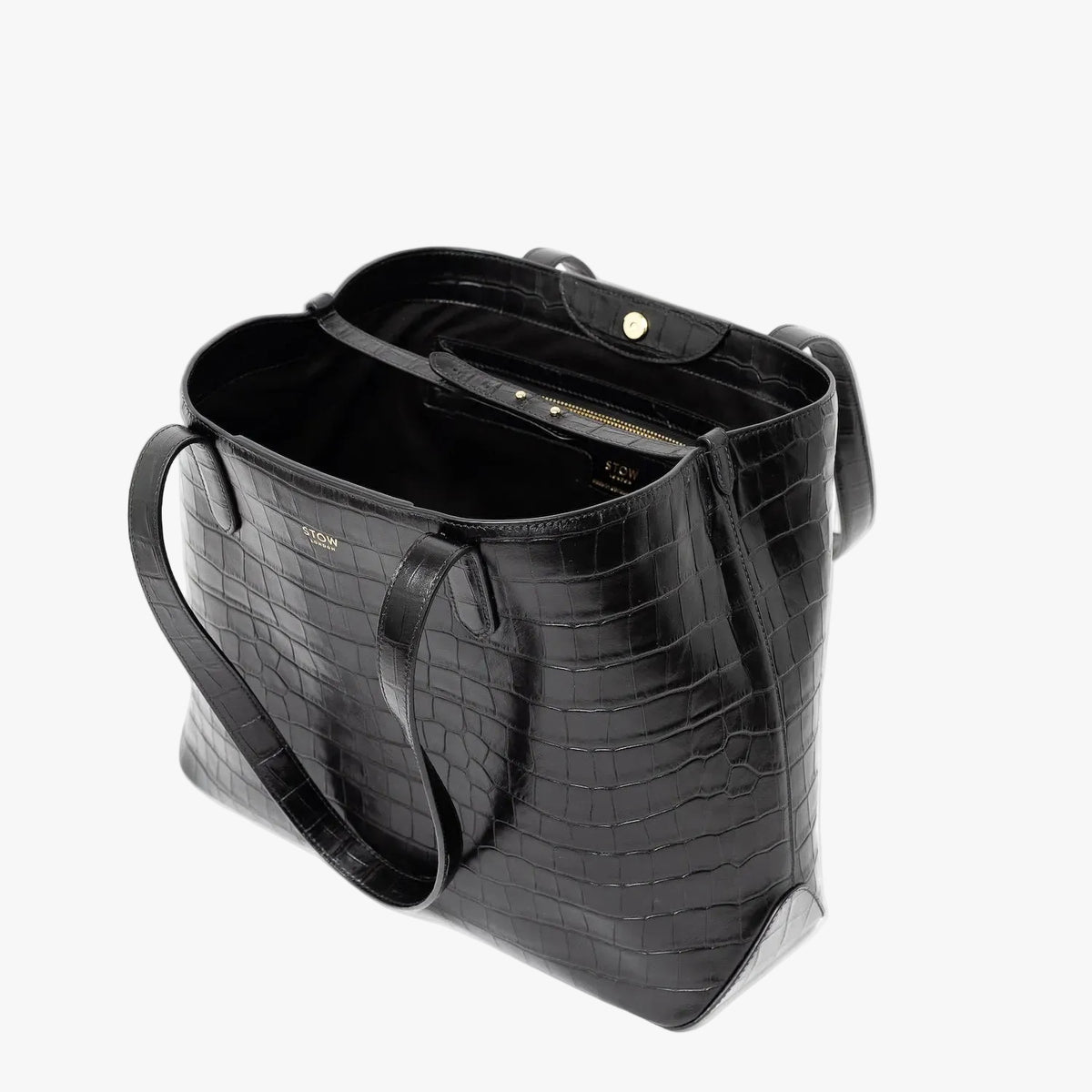 Stow London's Everyday Tote Bag in Black Embossed Croc leather on a light grey background with magnets open showing black cotton interior, leather strap, magnetic closure and zip pocket