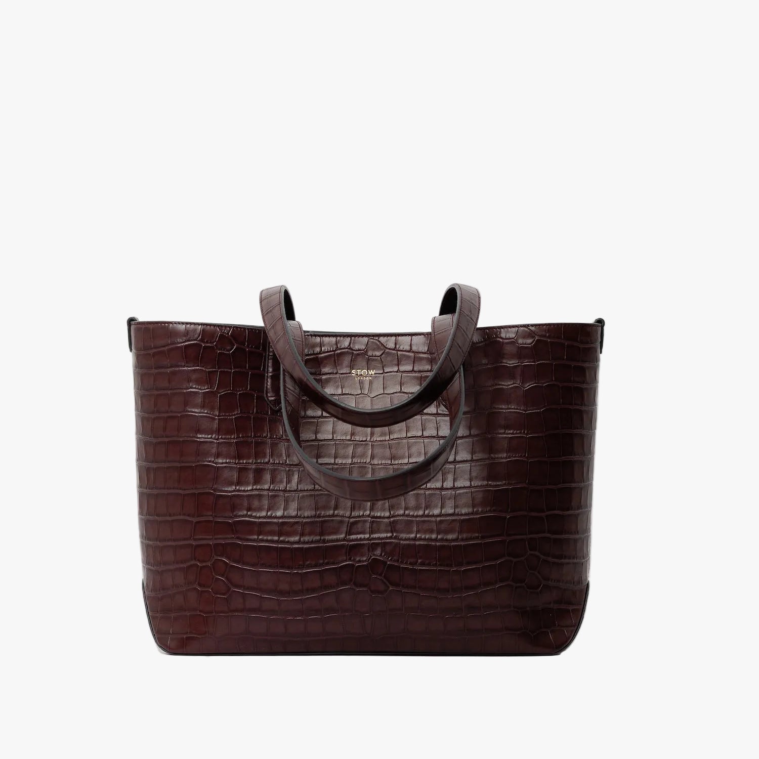 Stow London's Everyday Tote Bag in Burgundy Embossed Croc leather on a light grey background featuring gold STOW logo