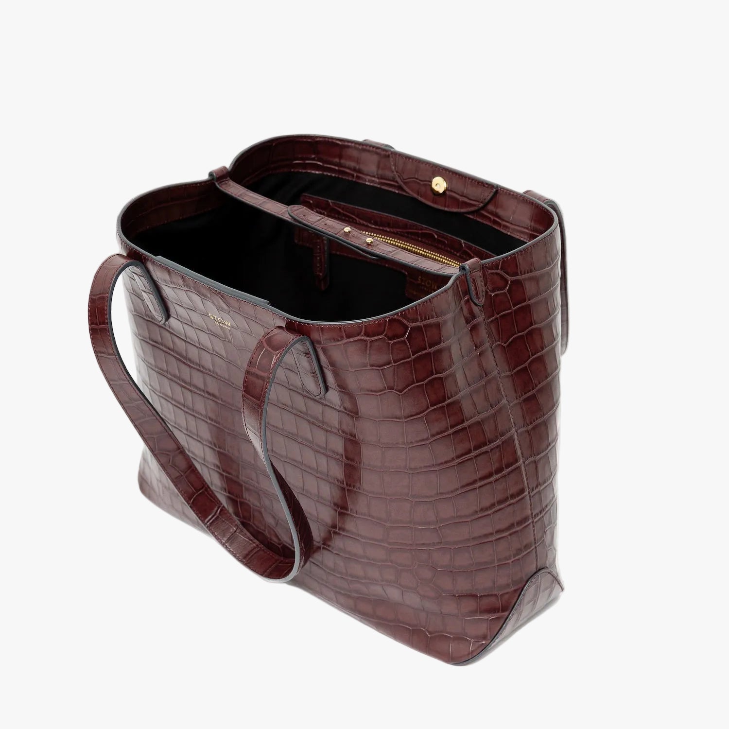 Stow London's Everyday Tote Bag in Burgundy Embossed Croc leather on a light grey background with magnets open showing black cotton interior, leather strap, magnetic closure and zip pocket featuring gold- coated stainless steel hardware