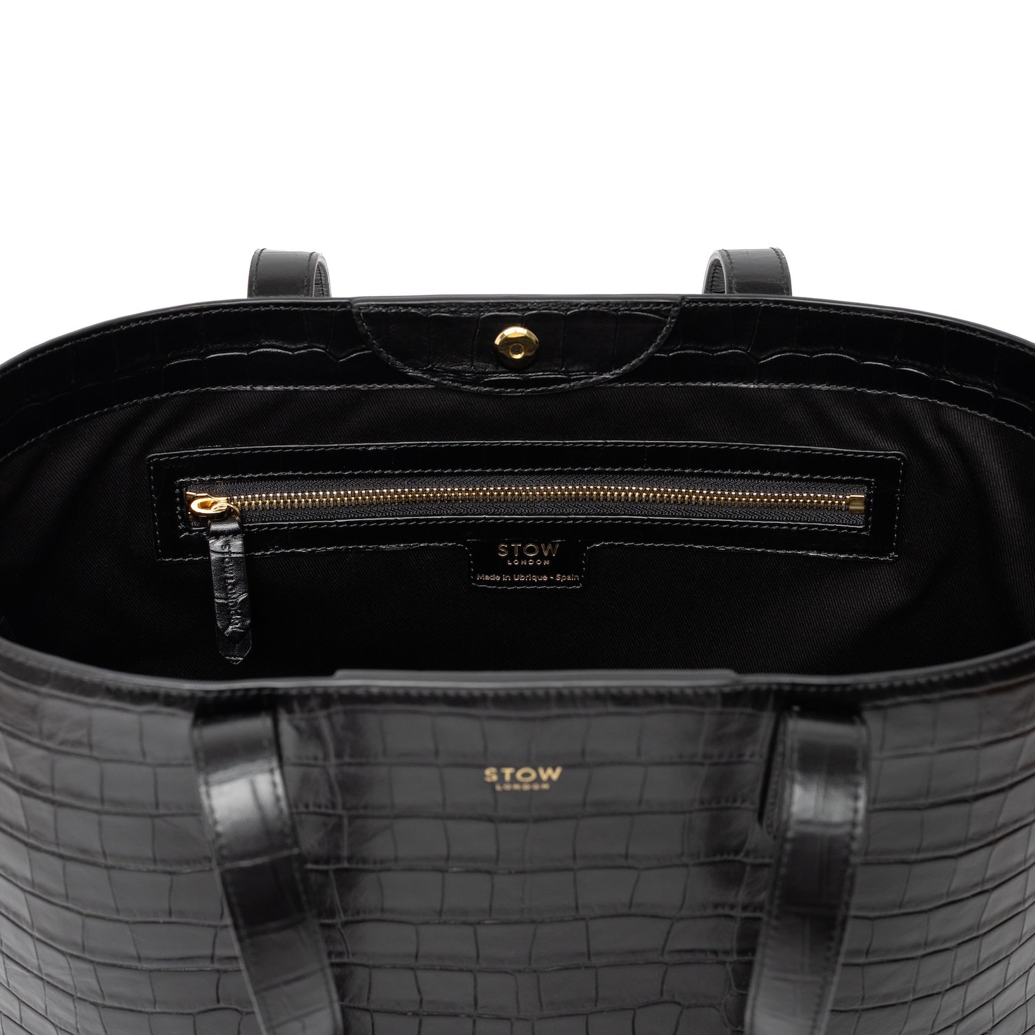 Close up of interior zip pocket and gold hardware on Black Embossed Croc Everyday Tote Bag shown on a white background