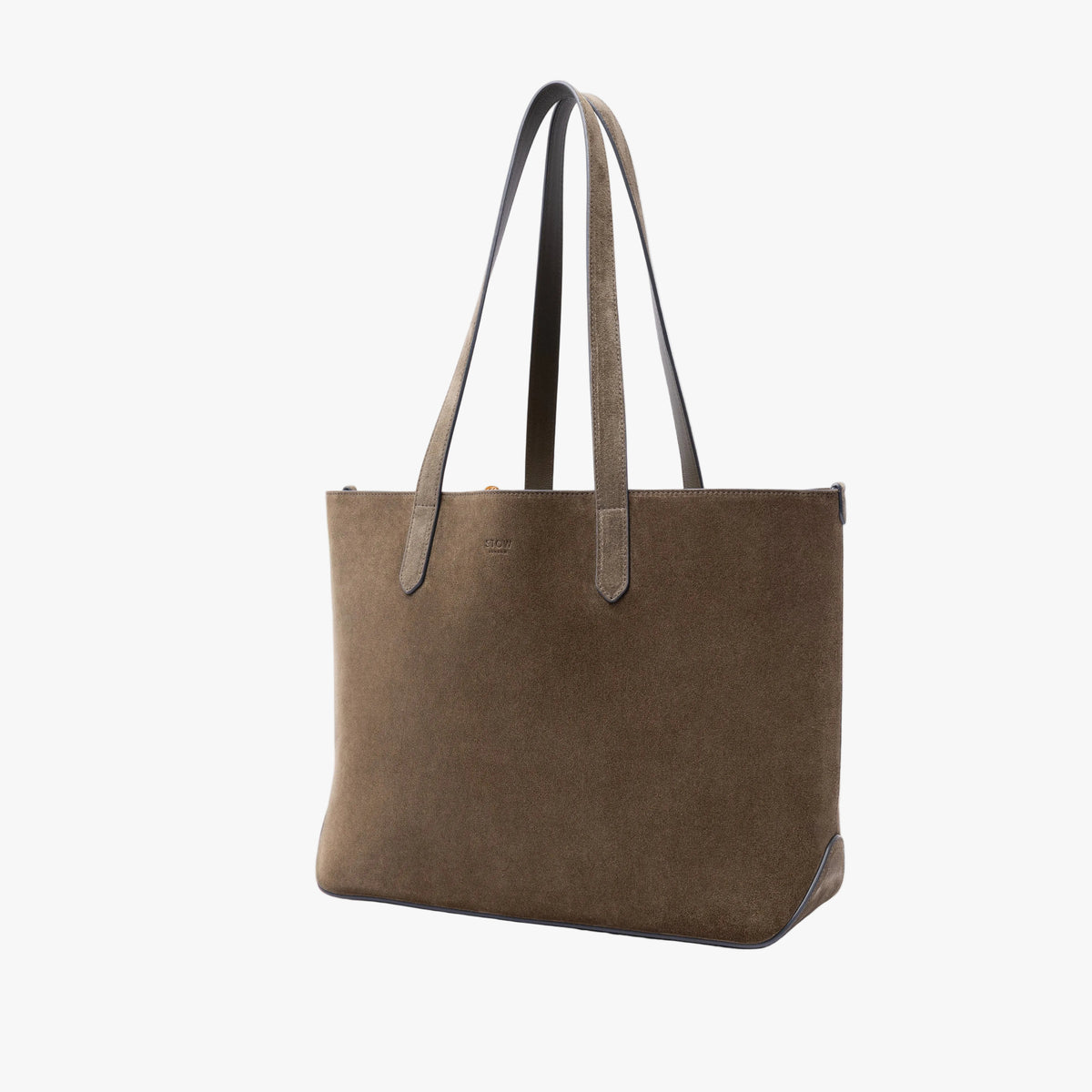 Off-axis view of STOW London's Everyday Tote bag in Navy suede on a light grey background featuring a small STOW London logo embossed on the front panel