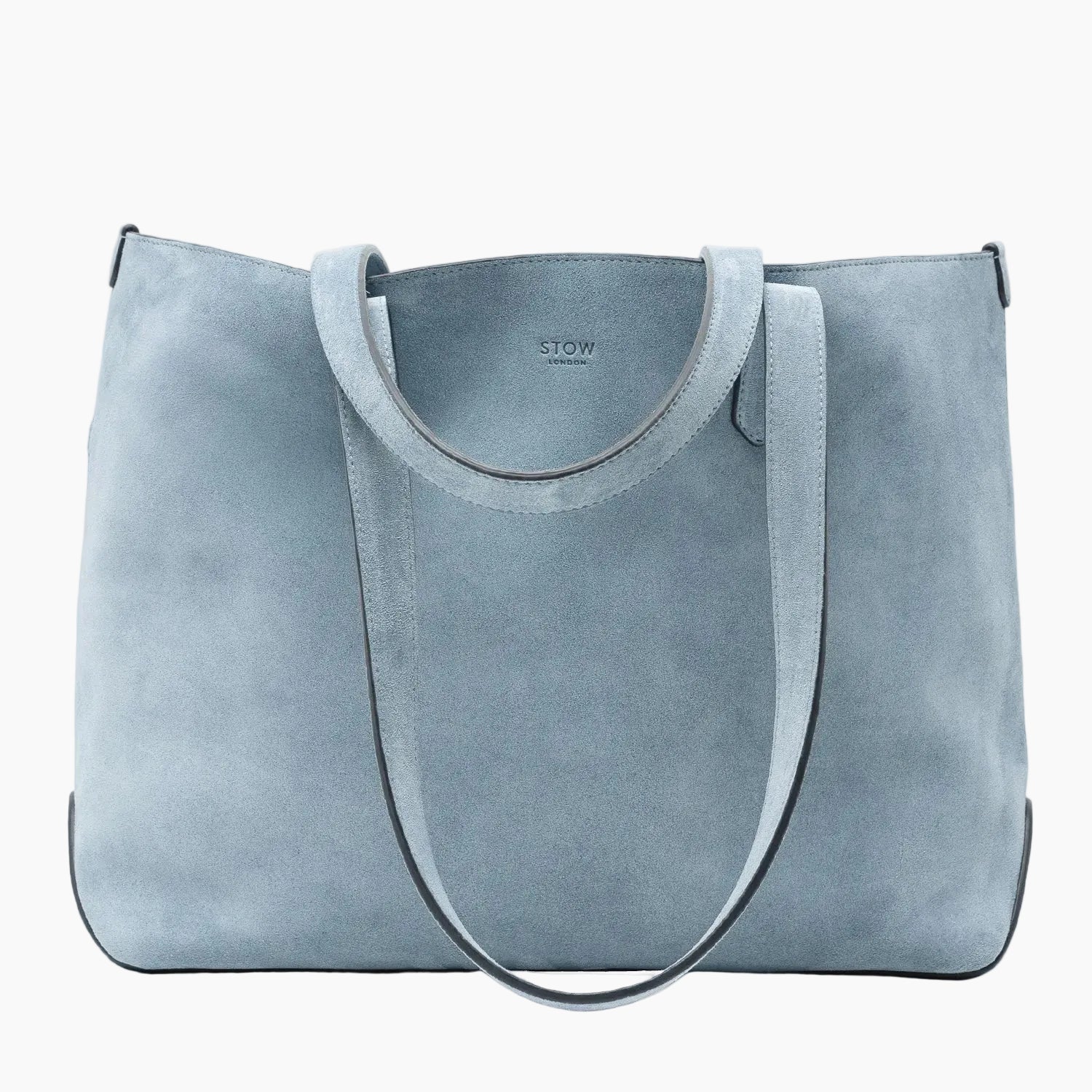 STOW London's Everyday Tote bag in Misty Blue suede on a light grey background featuring a small STOW London logo embossed on the front panel