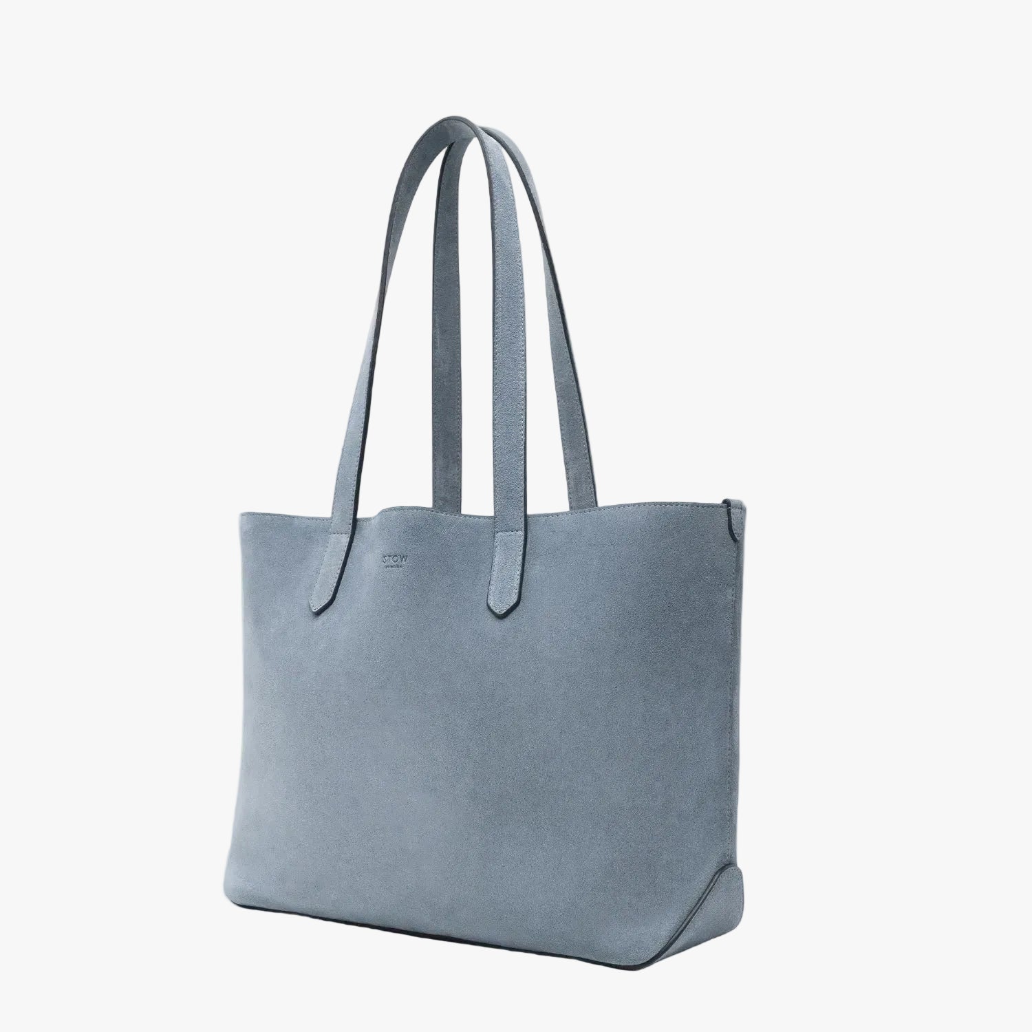 STOW London's Everyday Tote bag in Misty Blue suede on a light grey background featuring a small STOW London logo embossed on the front panel
