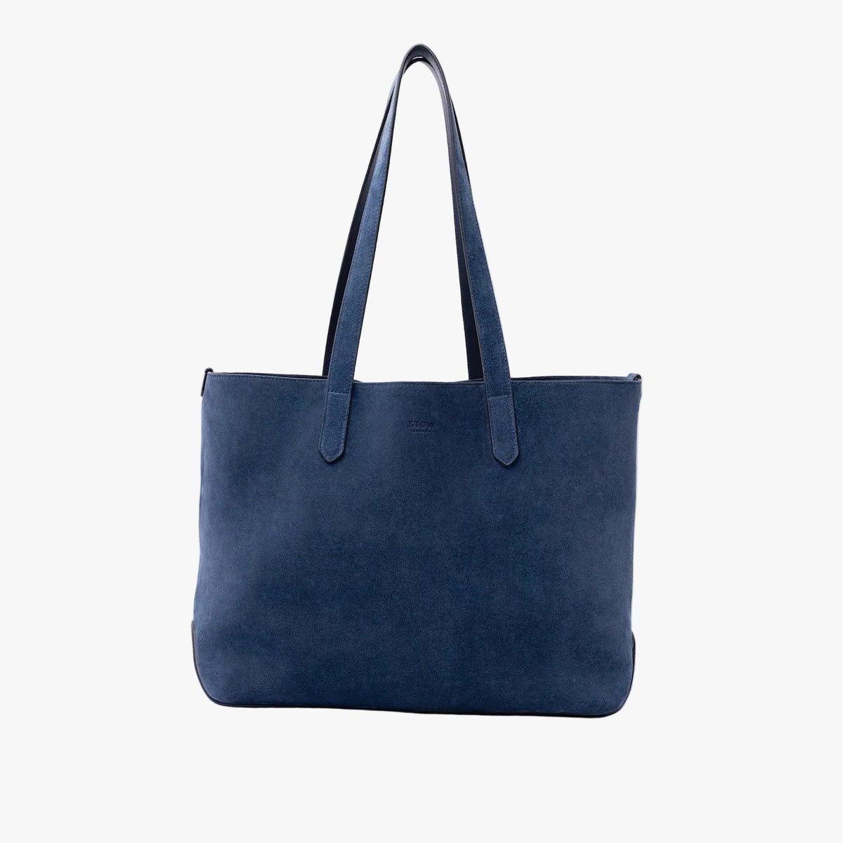 STOW London's Everyday Tote bag in Navy suede on a light grey background featuring a small STOW London logo embossed on the front panel