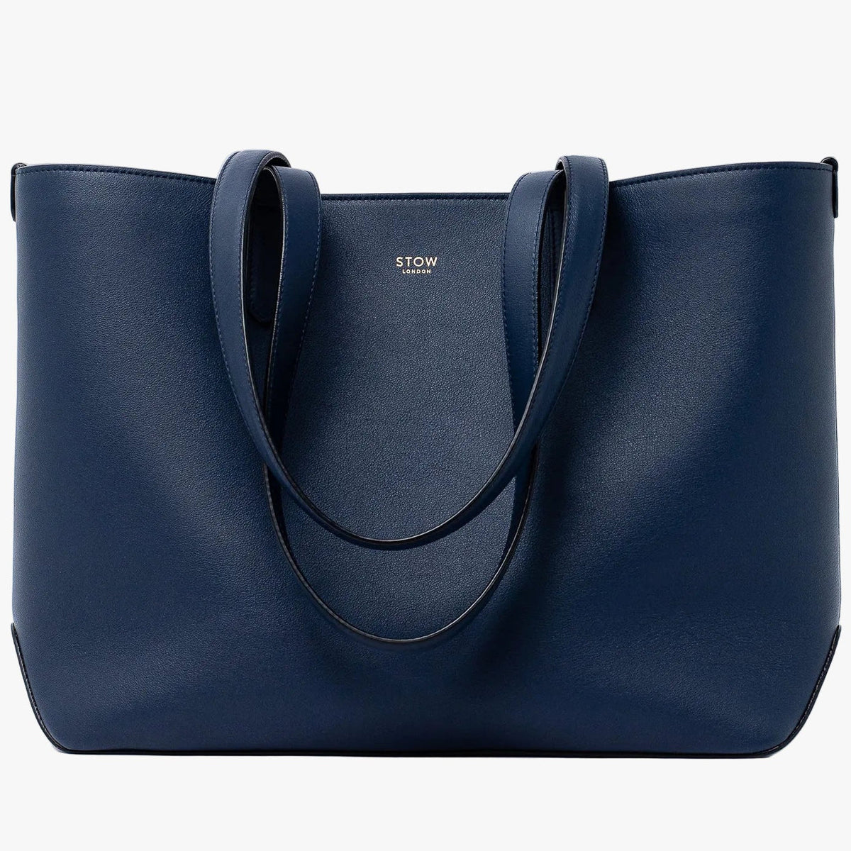 Stow London's Everyday Tote Bag in Navy smooth leather on a light grey background featuring gold STOW logo
