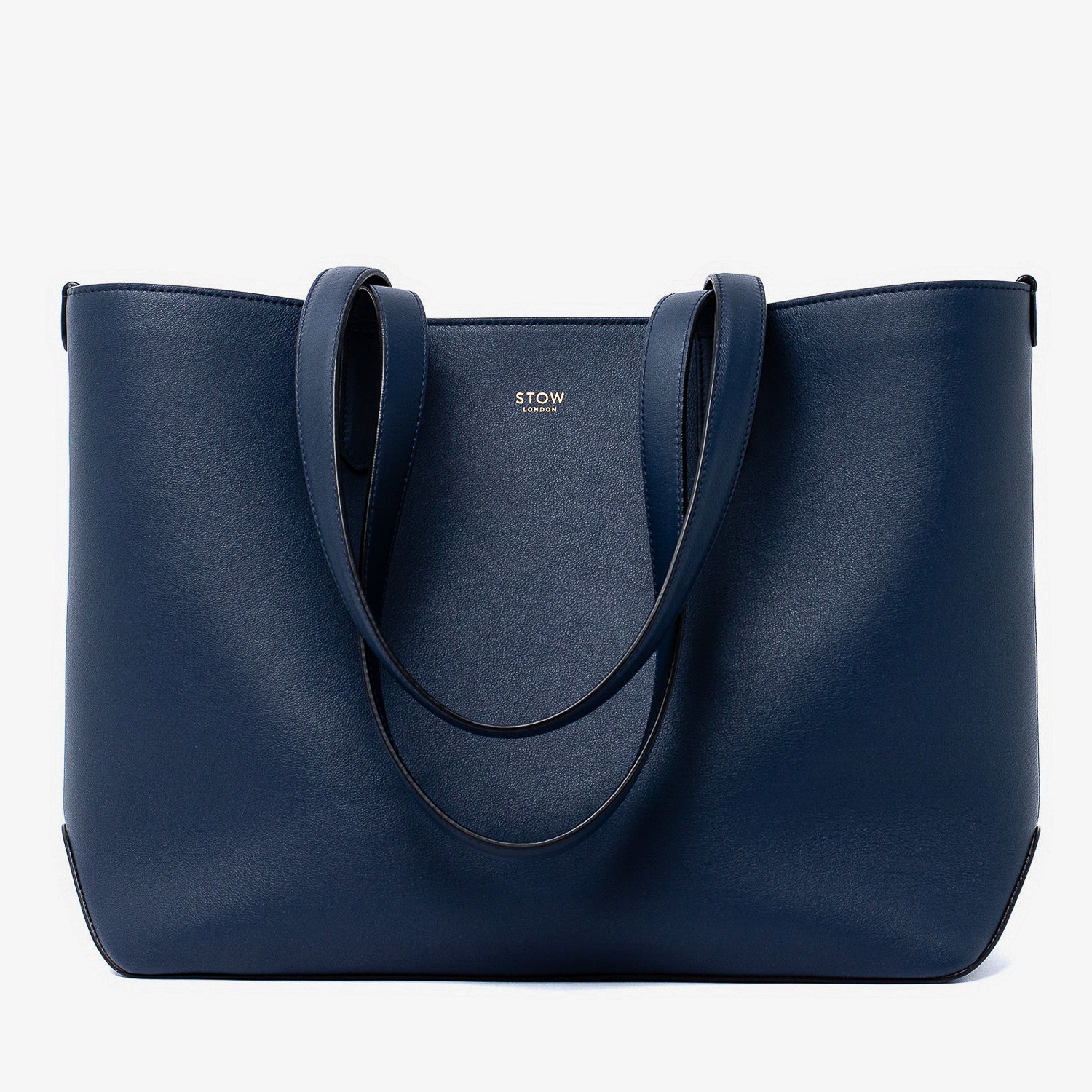 Stow London's Everyday Tote Bag in Navy smooth leather on a light grey background featuring gold STOW logo