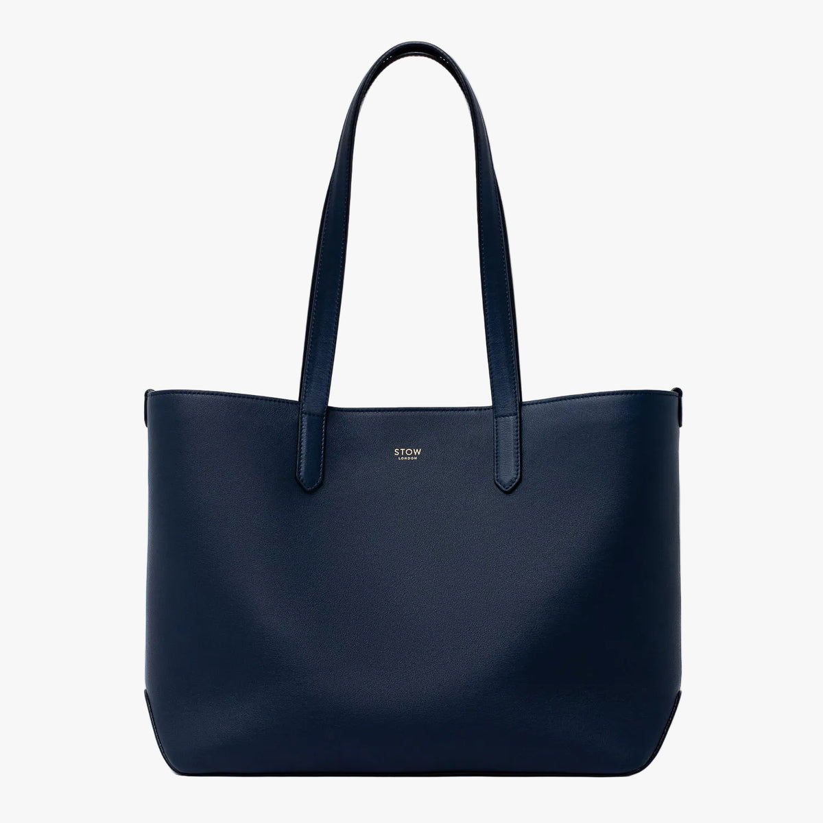 Stow London's Everyday Tote Bag in Navy smooth leather on a light grey background featuring gold STOW logo