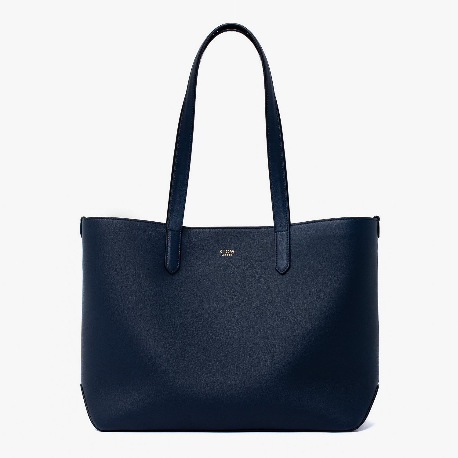 Stow London's Everyday Tote Bag in Navy smooth leather on a light grey background featuring gold STOW logo