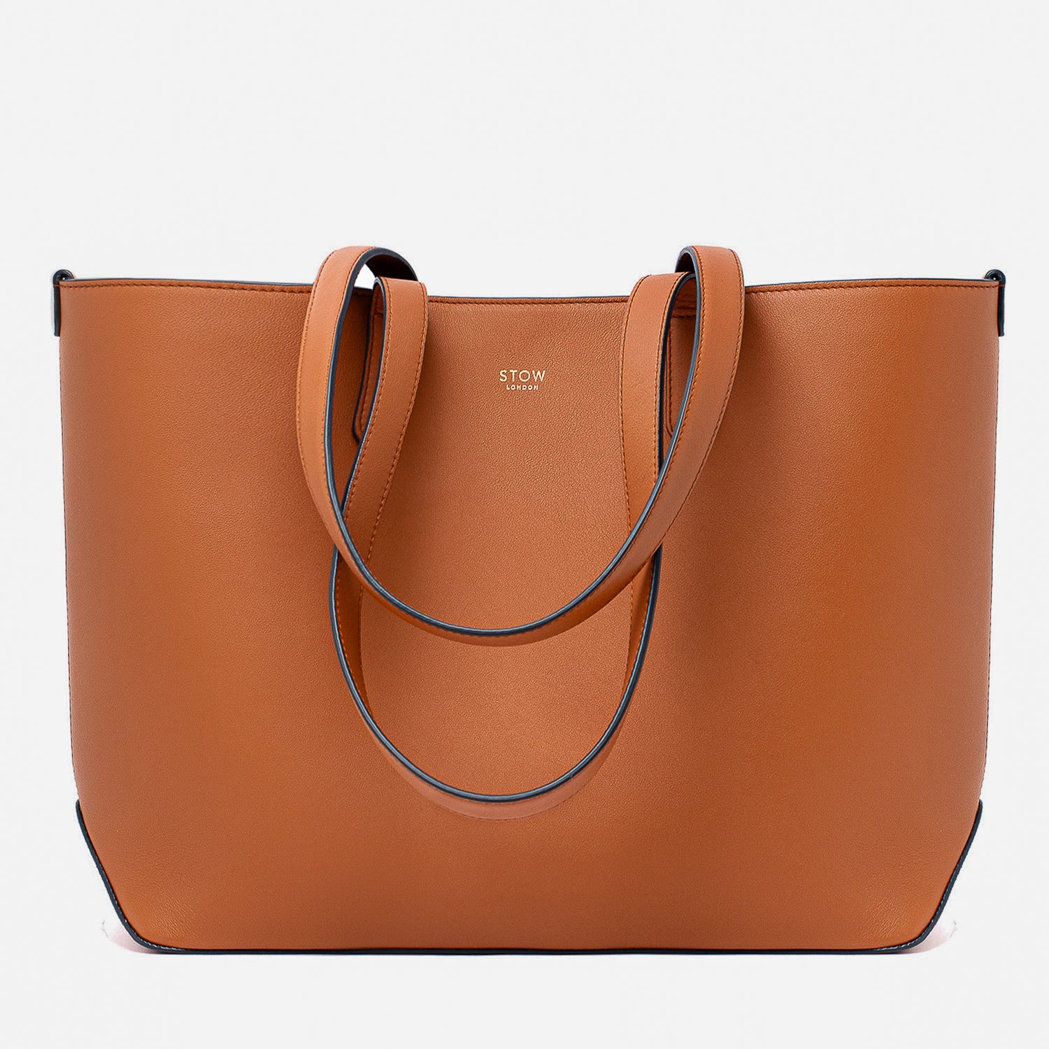 Stow London's Everyday Tote Bag in Earth Tan smooth leather on a light grey background featuring gold STOW logo