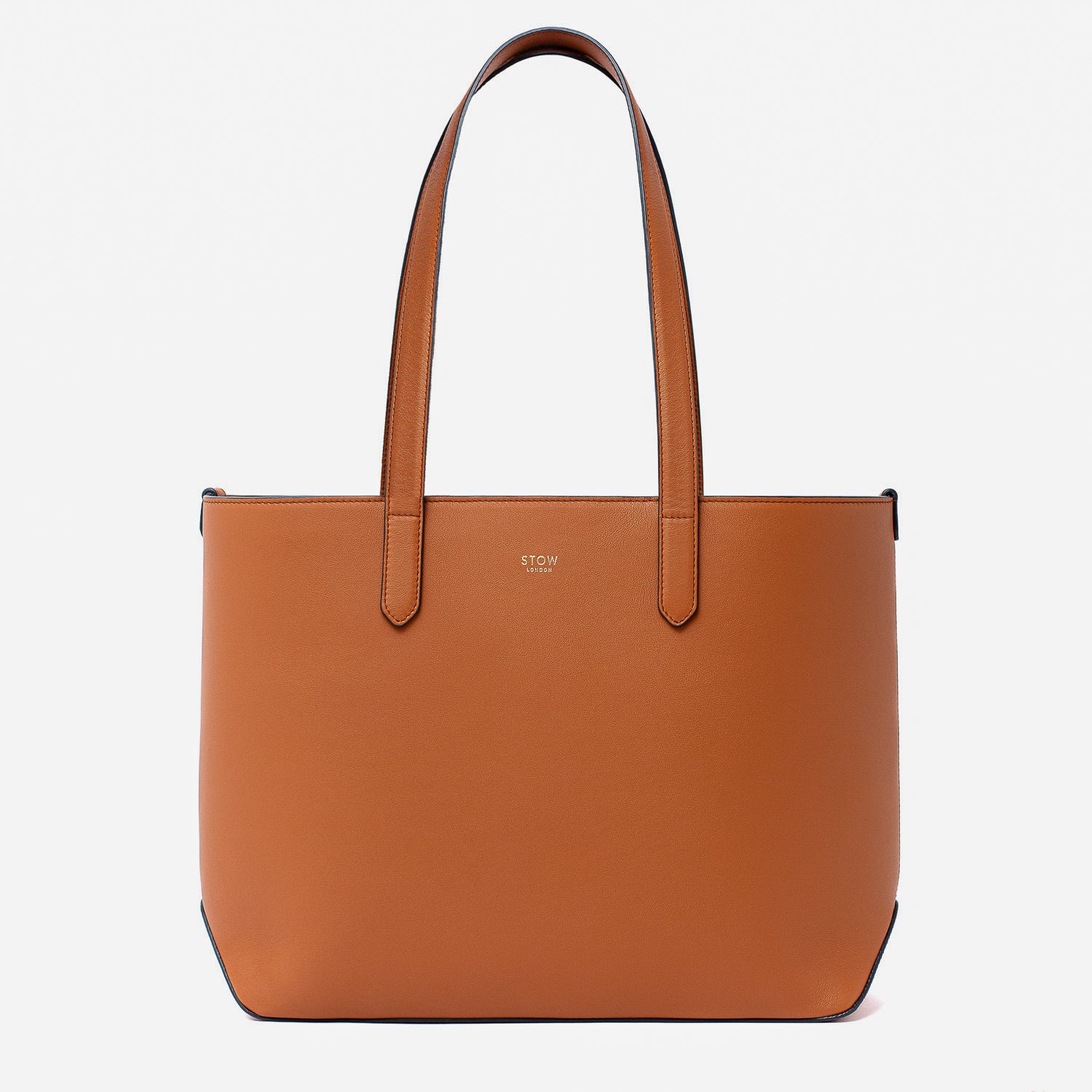 Stow London's Everyday Tote Bag in Earth Tan smooth leather on a light grey background featuring gold STOW logo