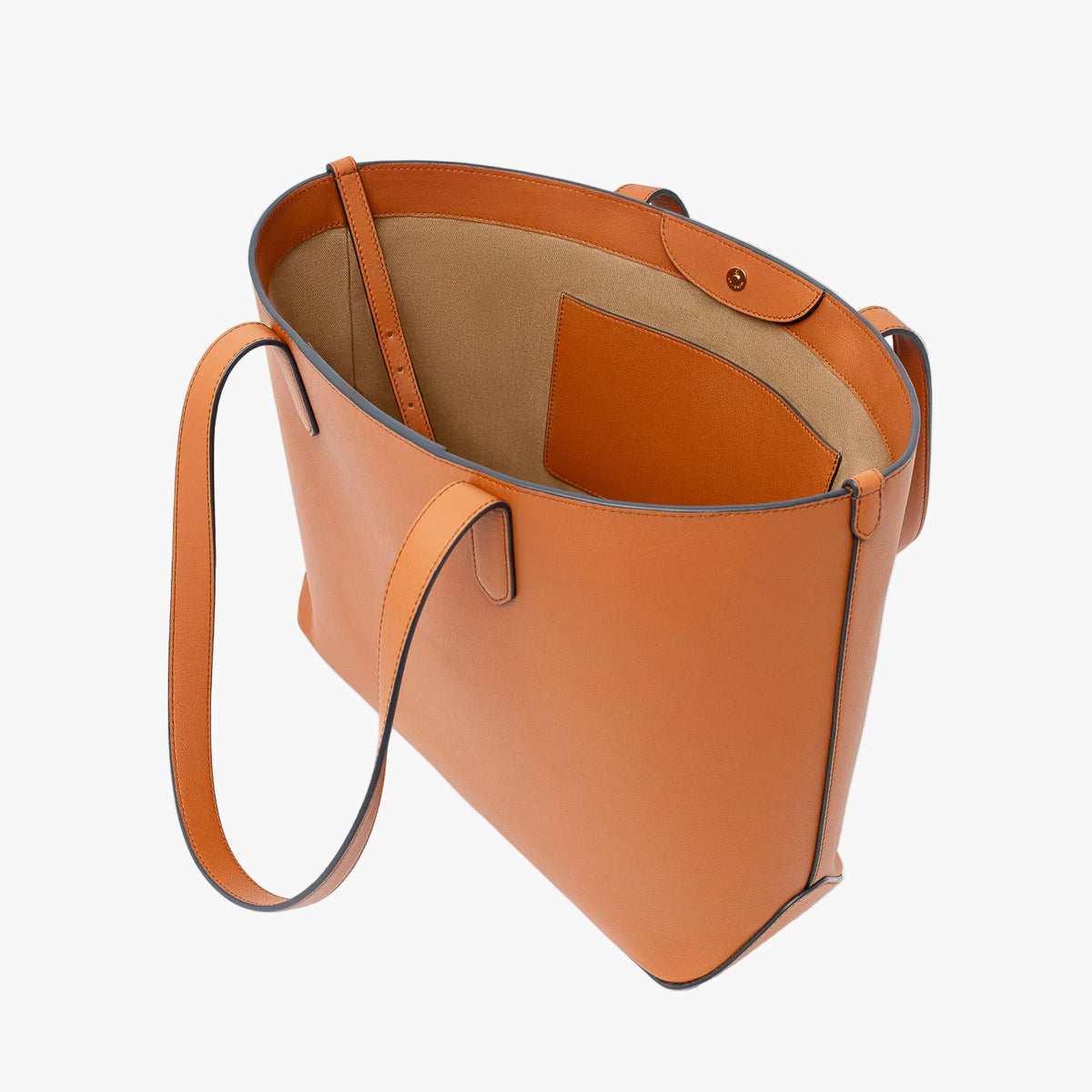 Stow London's Everyday Tote Bag in Earth Tan smooth leather with magnets open showing cotton interior, leather strap and slip pocket on a light grey background