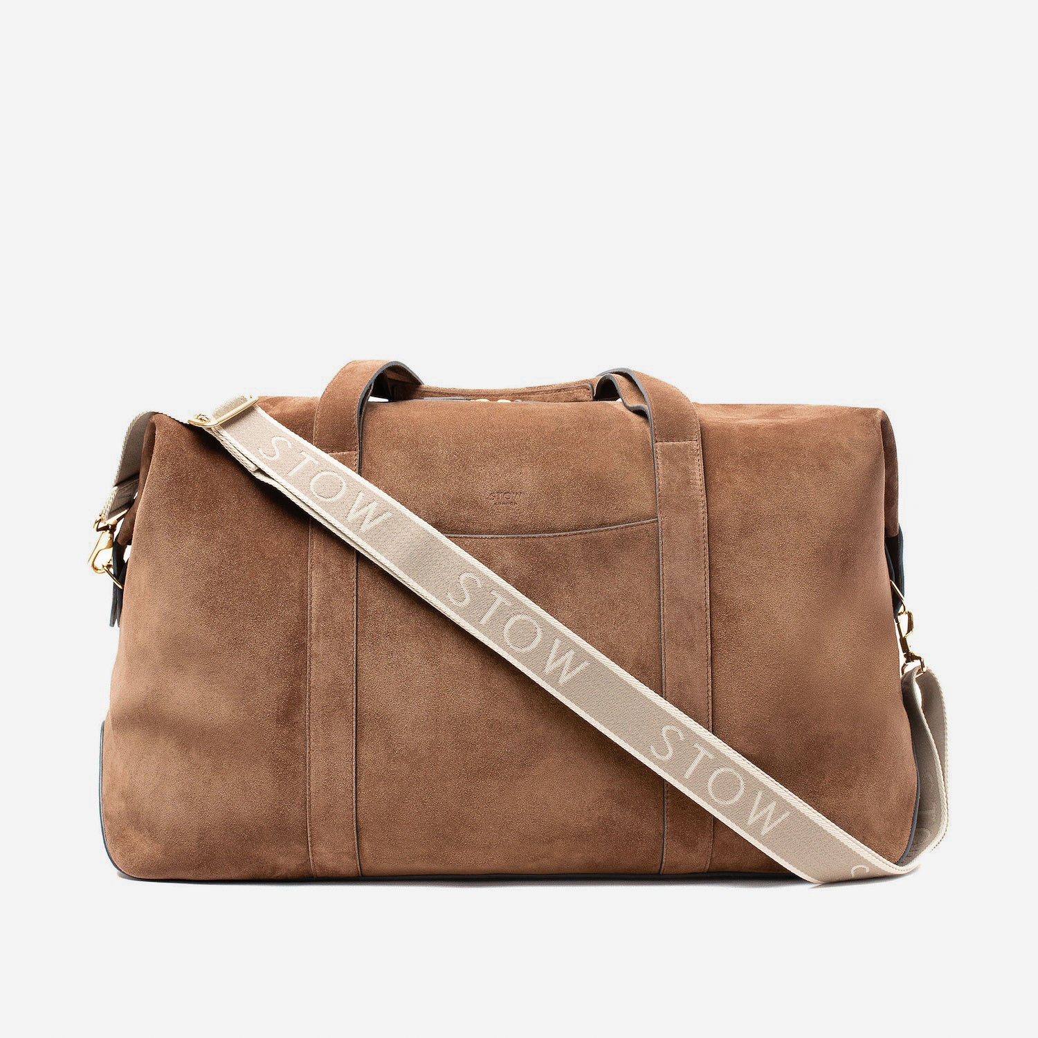STOW London's Weekend bag in Chocolate suede leather with its detachable branded STOW webbing strap on a light grey background